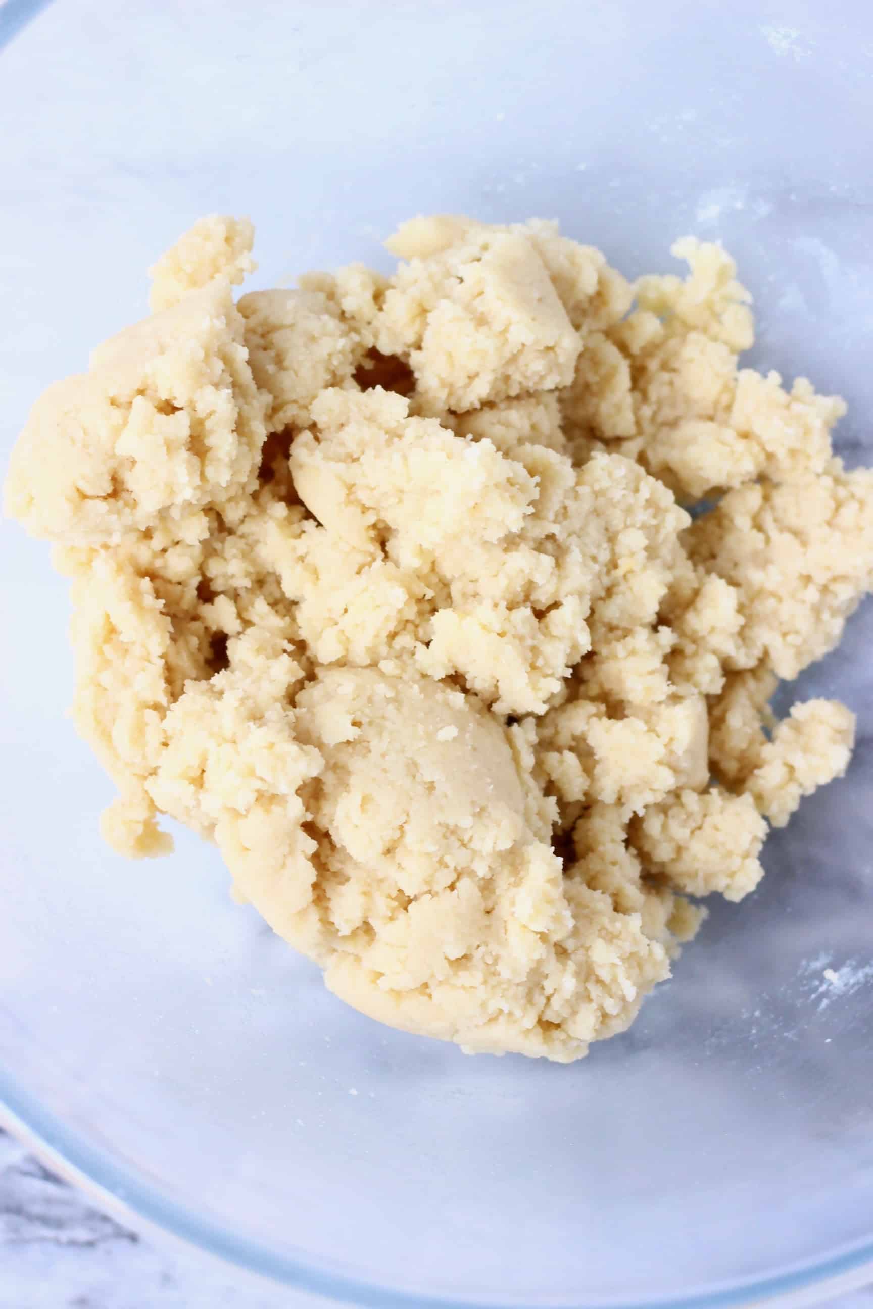 Raw gluten-free vegan sugar cookie dough in a glass mixing bowl