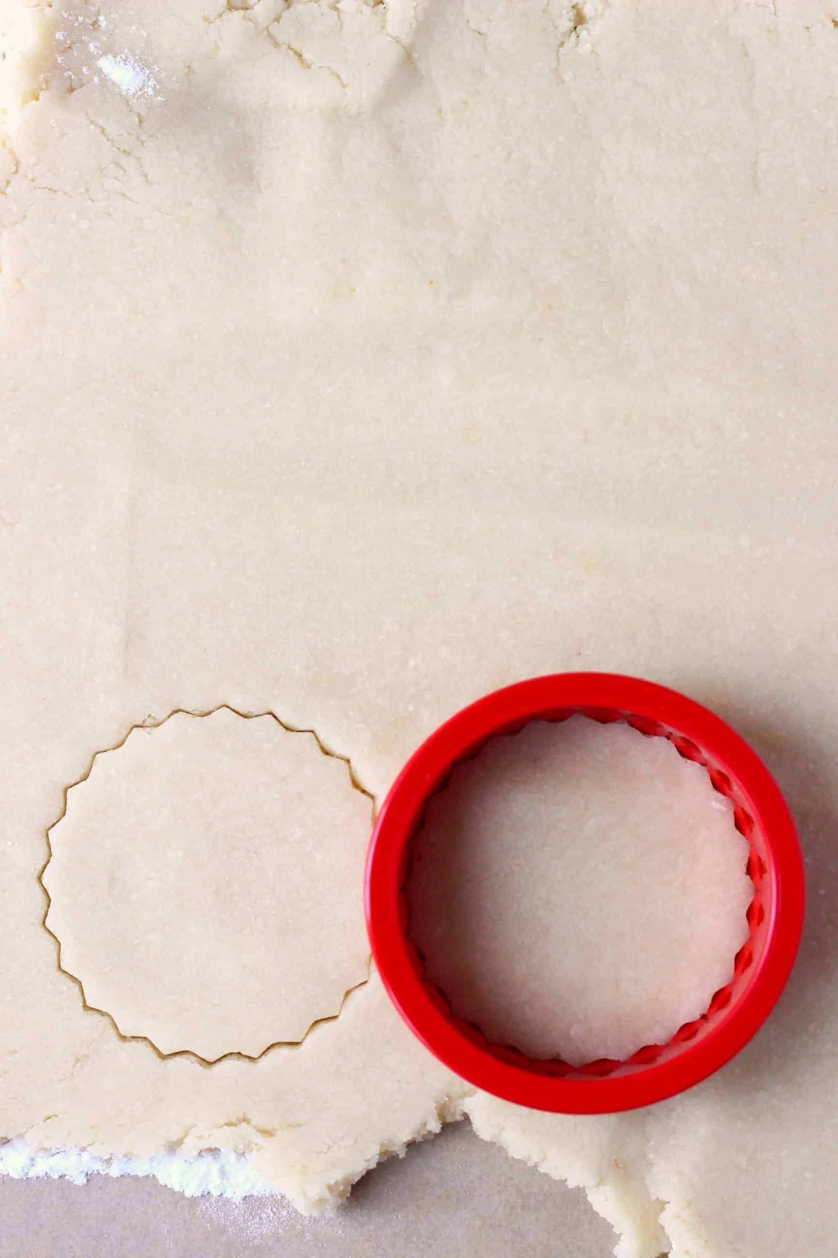 Gluten-free vegan sugar cookie dough with a circular cookie cutter on it