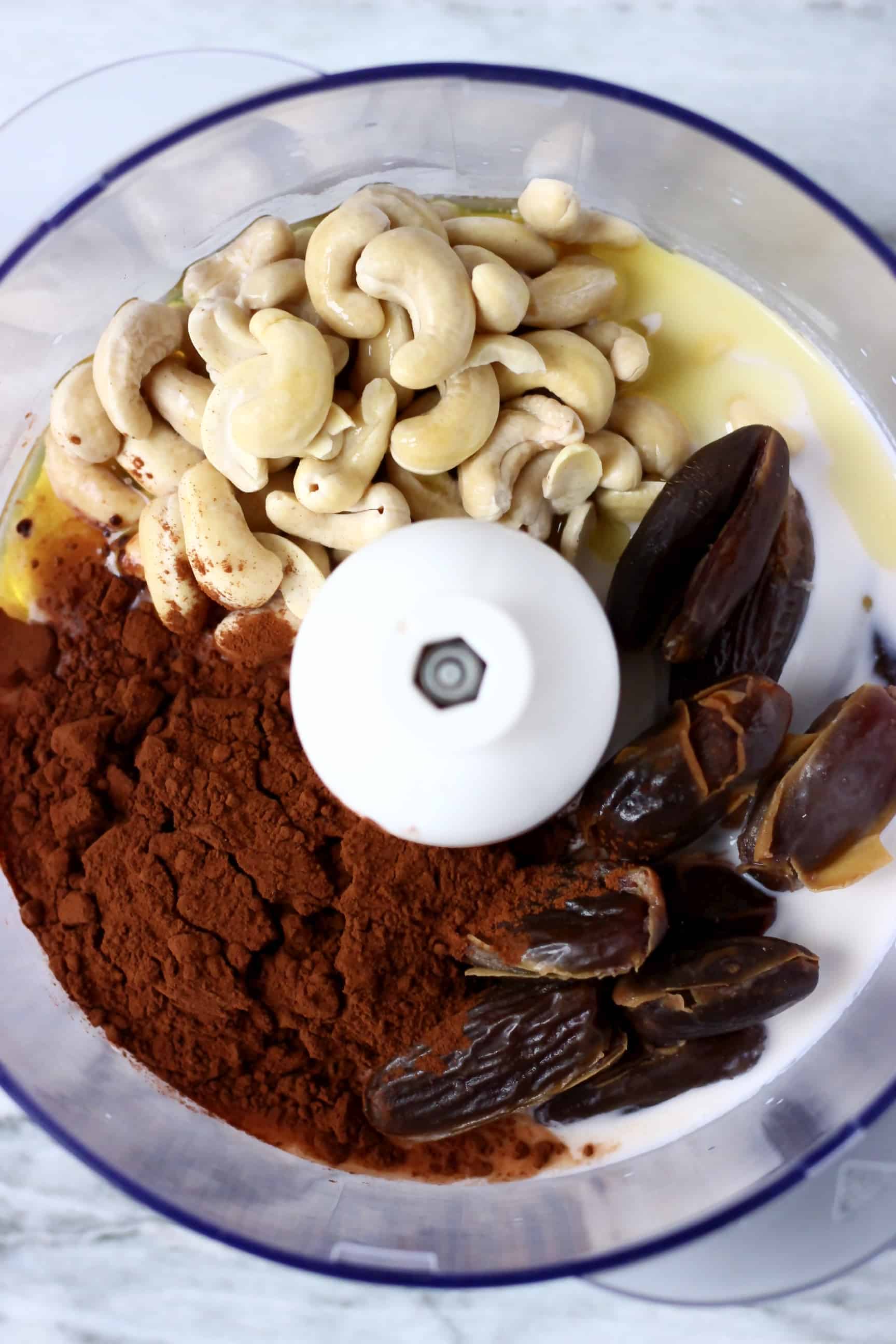 Cashew nuts, dates, cocoa powder and almond milk in a food processor