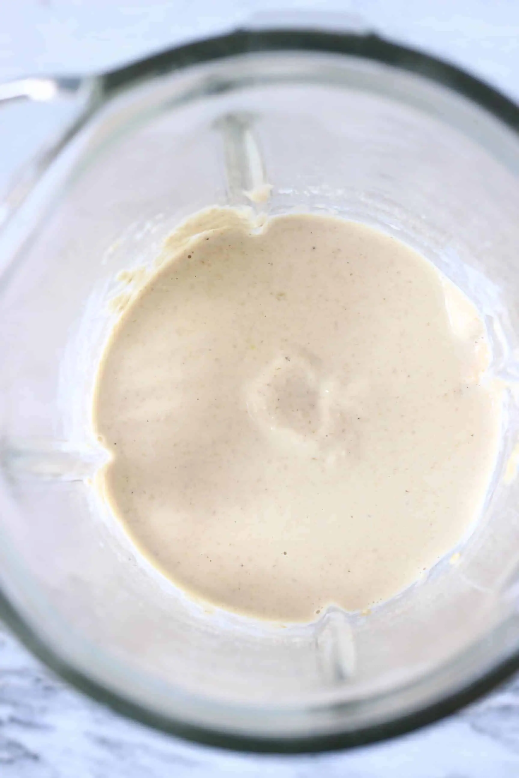 White gluten-free vegan protein pancake batter in a glass blender