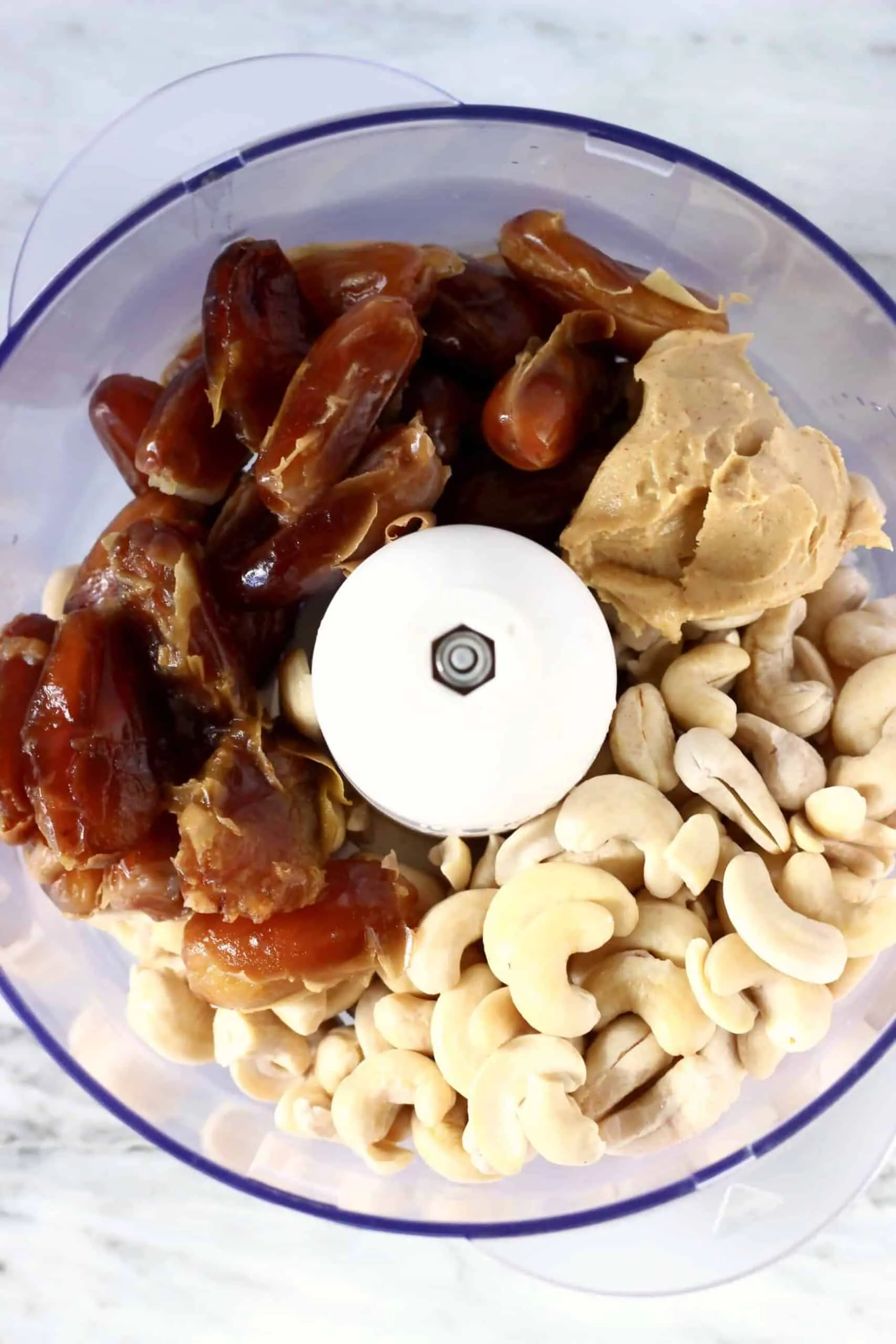 Cashew nuts, dates and almond butter in a food processor 