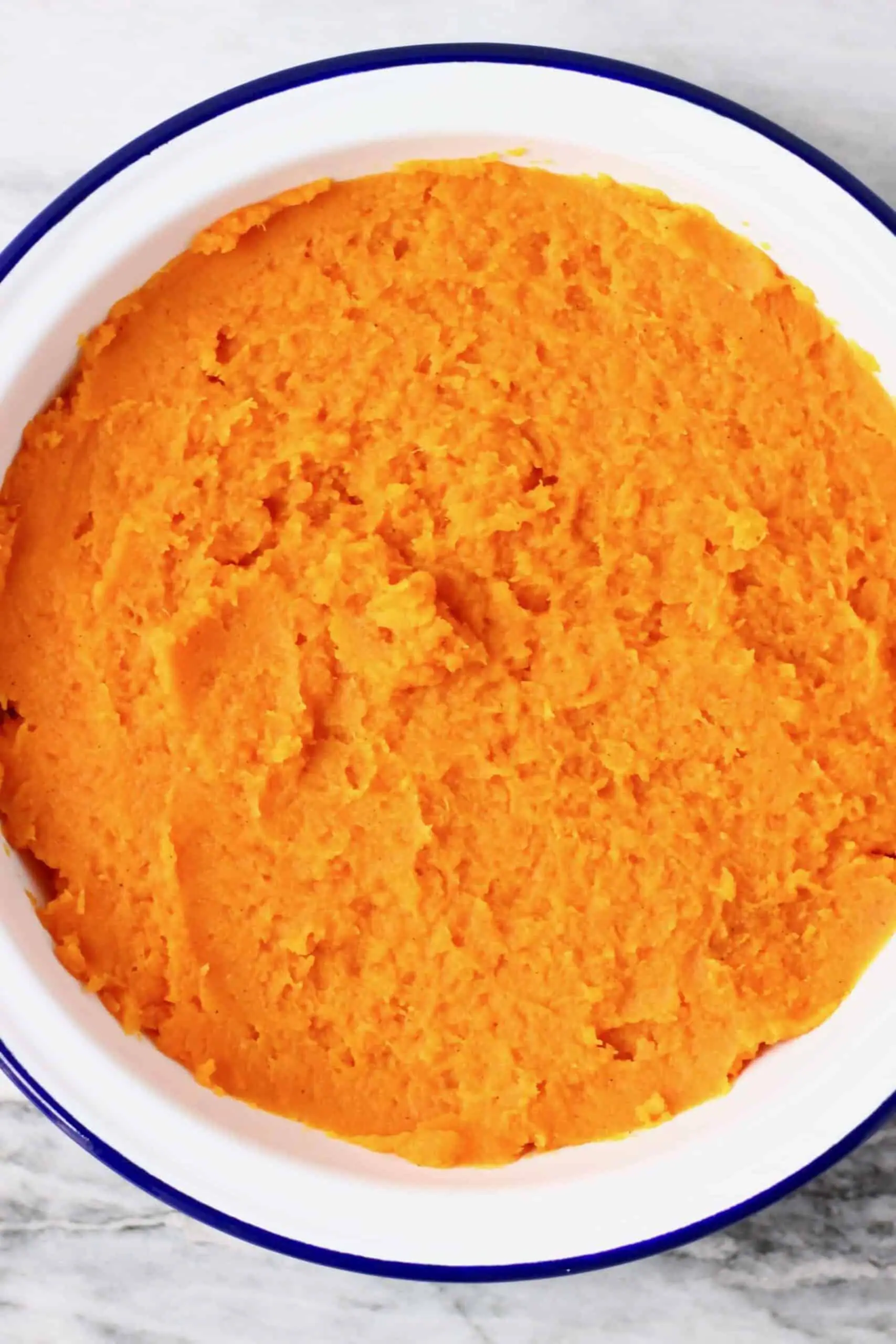 Mashed sweet potatoes in a pie dish