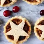 Three gluten-free vegan mince pies topped with pastry stars