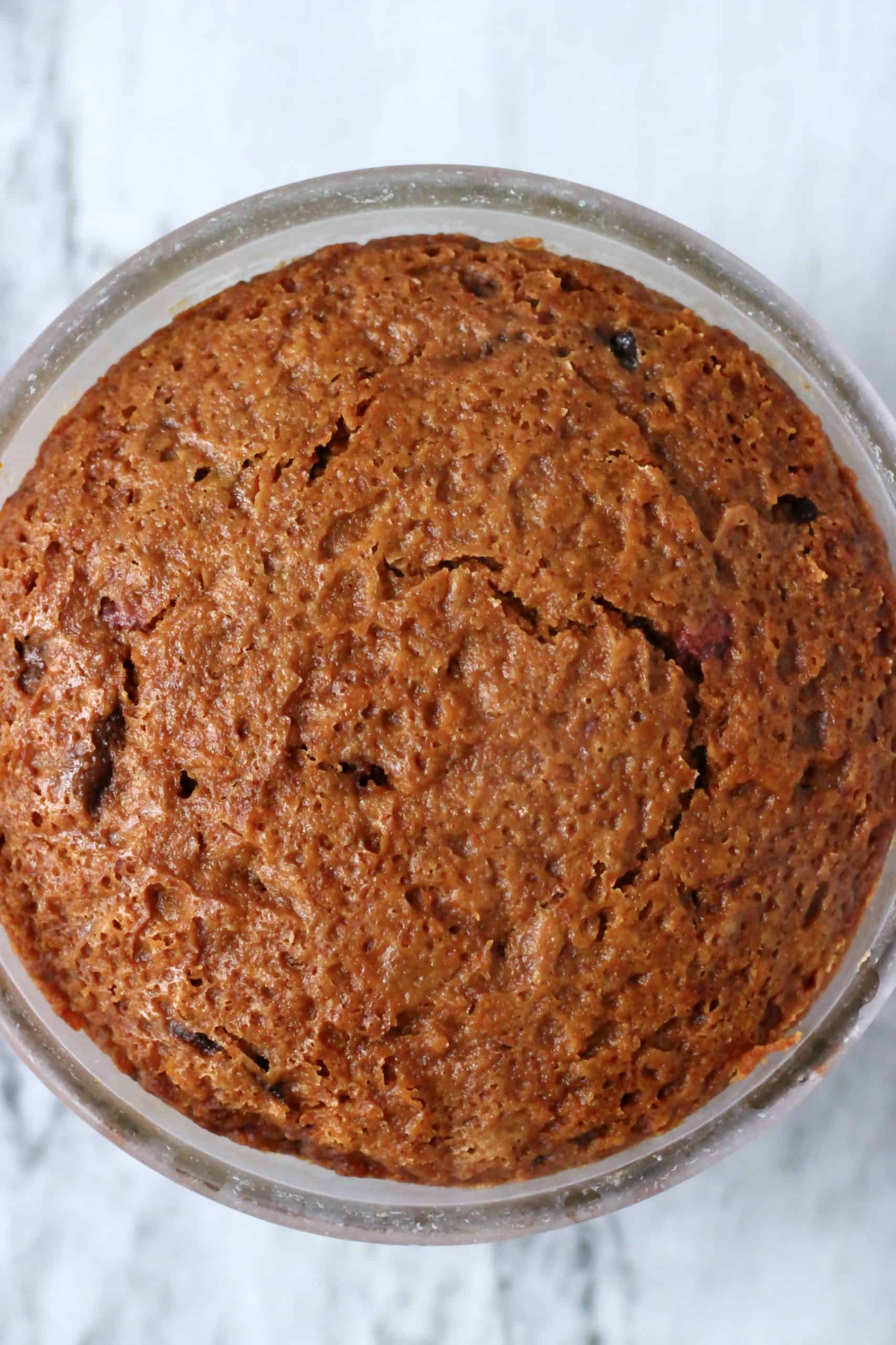 A gluten-free vegan Christmas pudding in a glass bowl