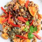 Pumpkin quinoa salad with red onion, roasted pumpkin and pumpkin seeds on plate