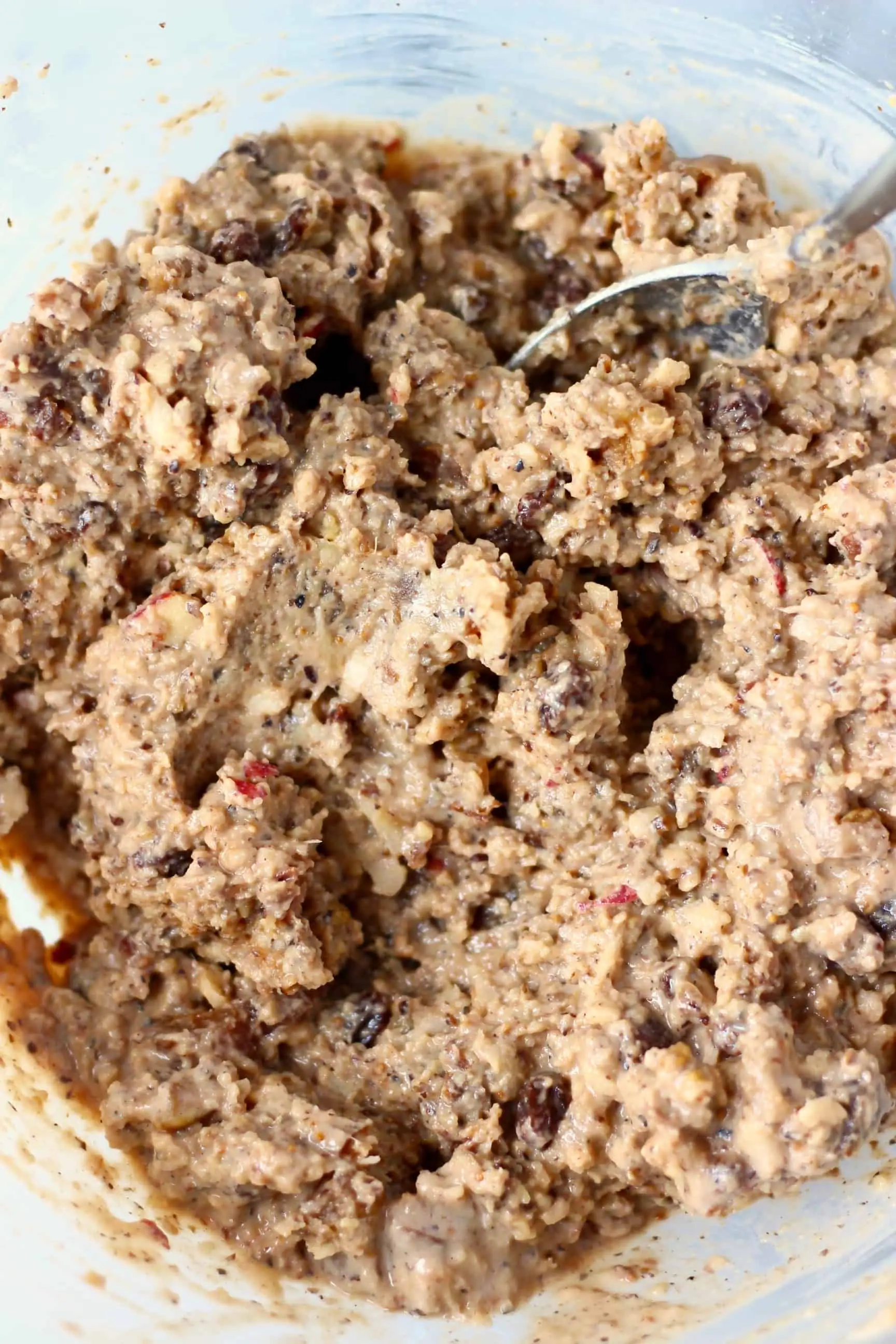 Raw gluten-free vegan Christmas pudding batter in a glass mixing bowl 