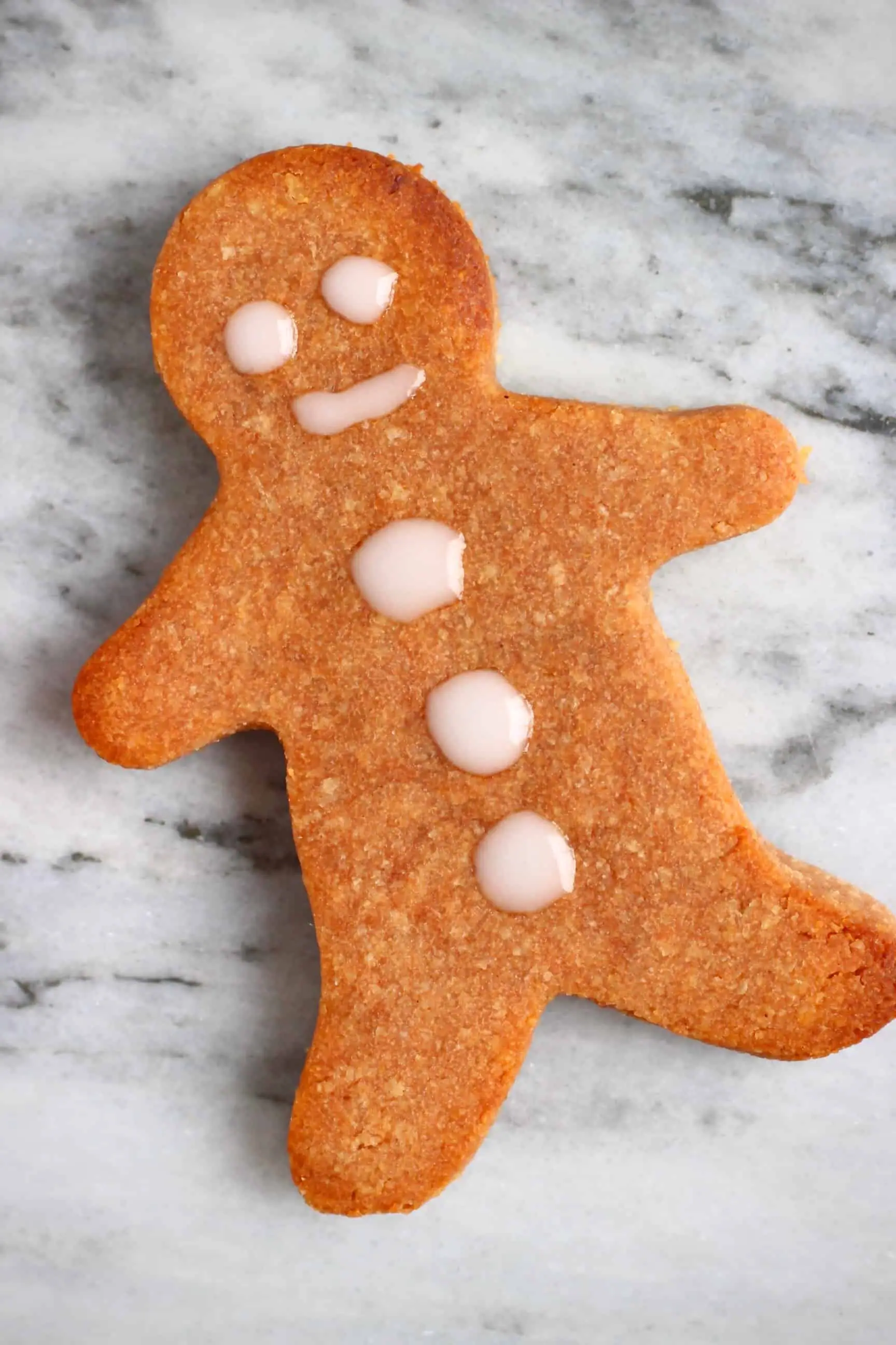 A gingerbread cookie man again a marble background