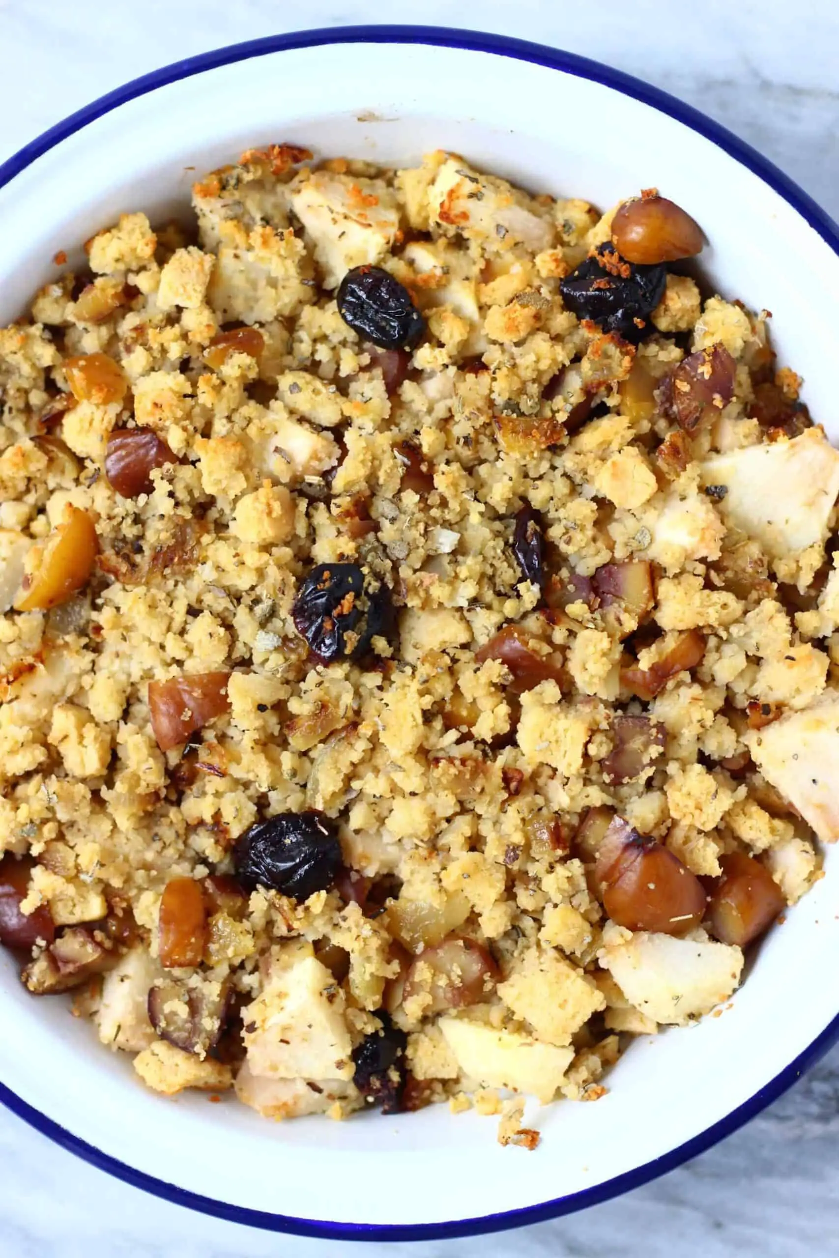 Gluten-free vegan stuffing with apple, dried cherries and chestnuts in a pie dish