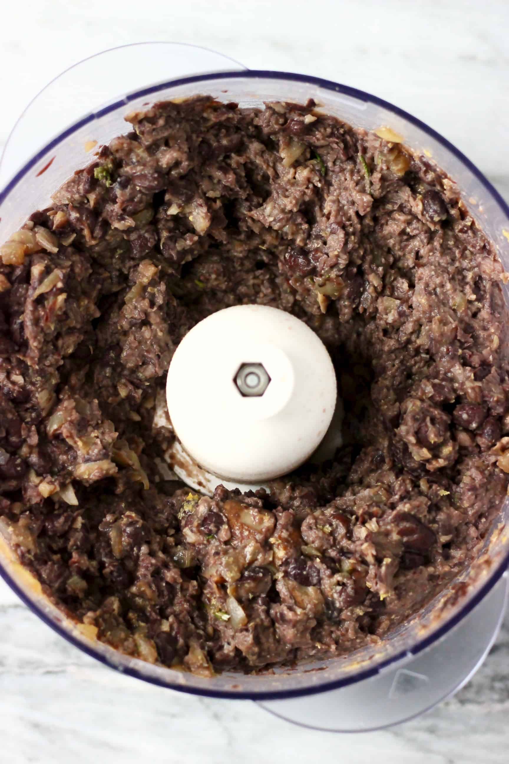 This Vegan Meatloaf is made with hearty black beans, earthy walnuts and savoury mushrooms - it's rich and flavourful, filling and satisfying and super easy to make! Perfect for Christmas, Thanksgiving and everything else in between! Vegetarian, gluten-free, dairy-free and egg-free. #rhiansrecipes #meatloaf #christmas #thanksgiving #vegan #dairyfree #glutenfree #vegetarian Vegan black bean meatloaf mixture in a food processor