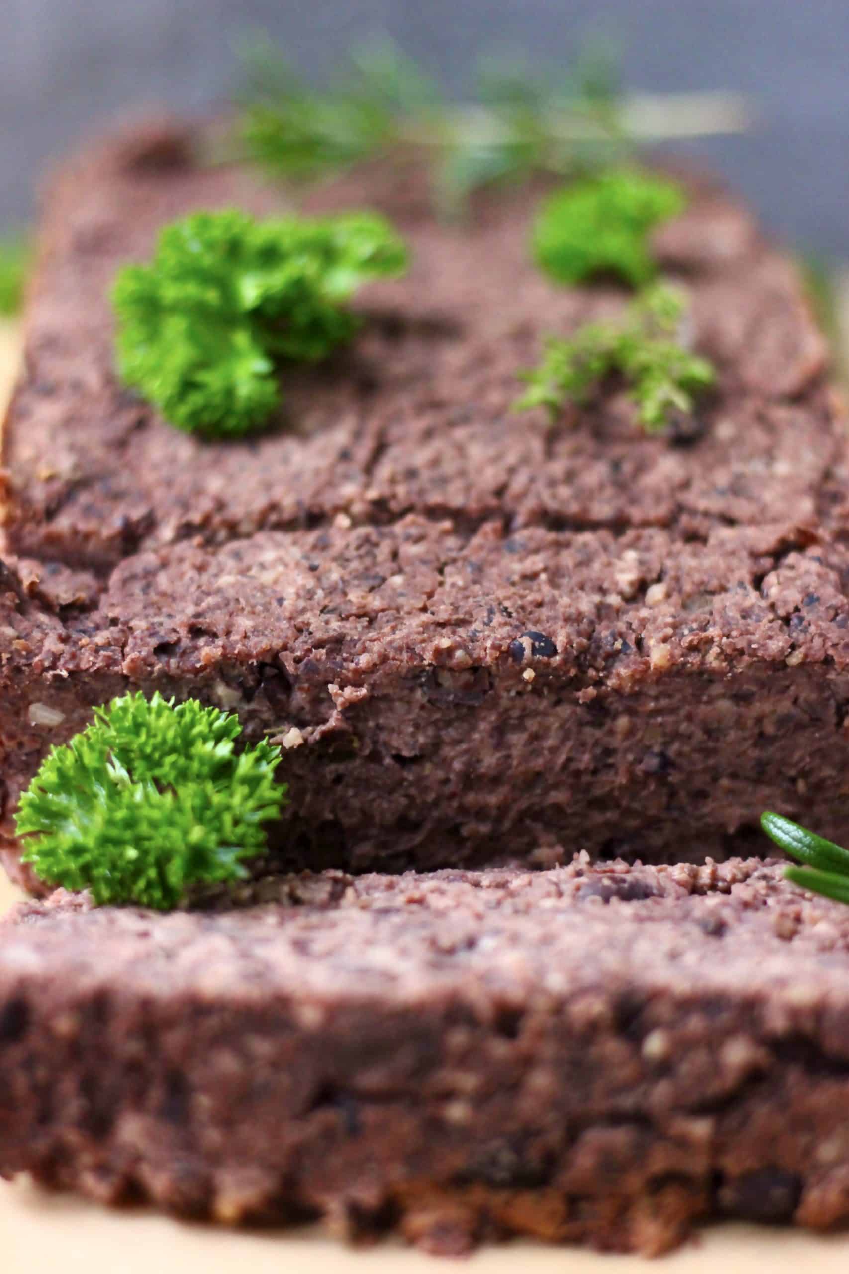 A black bean vegan meatloaf with two slices cut from it