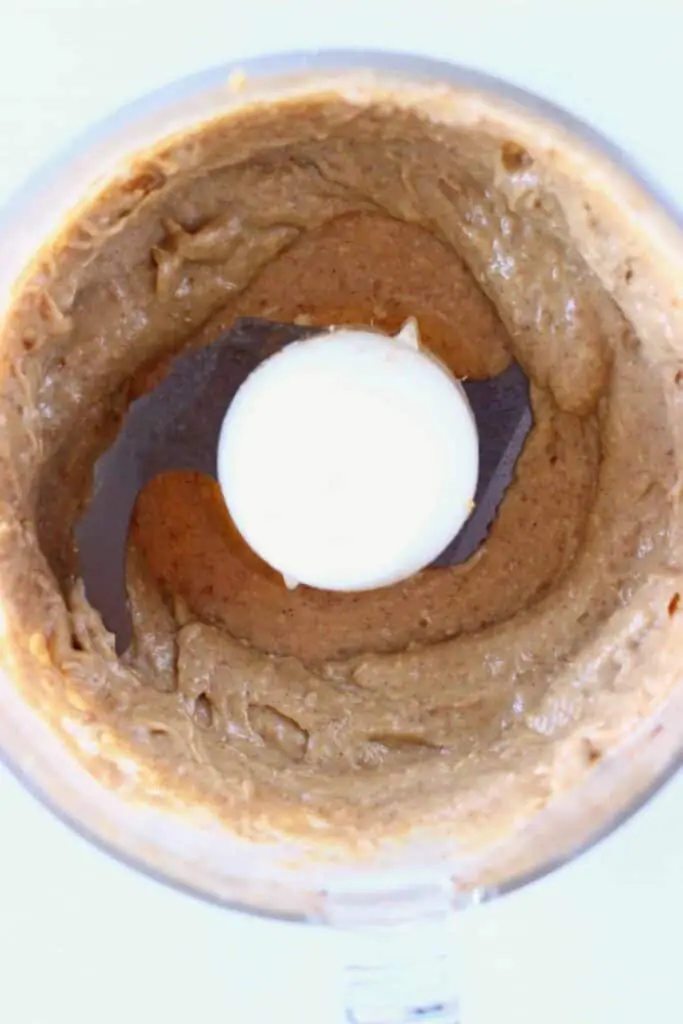 Brown caramel sauce in a food processor against a white background