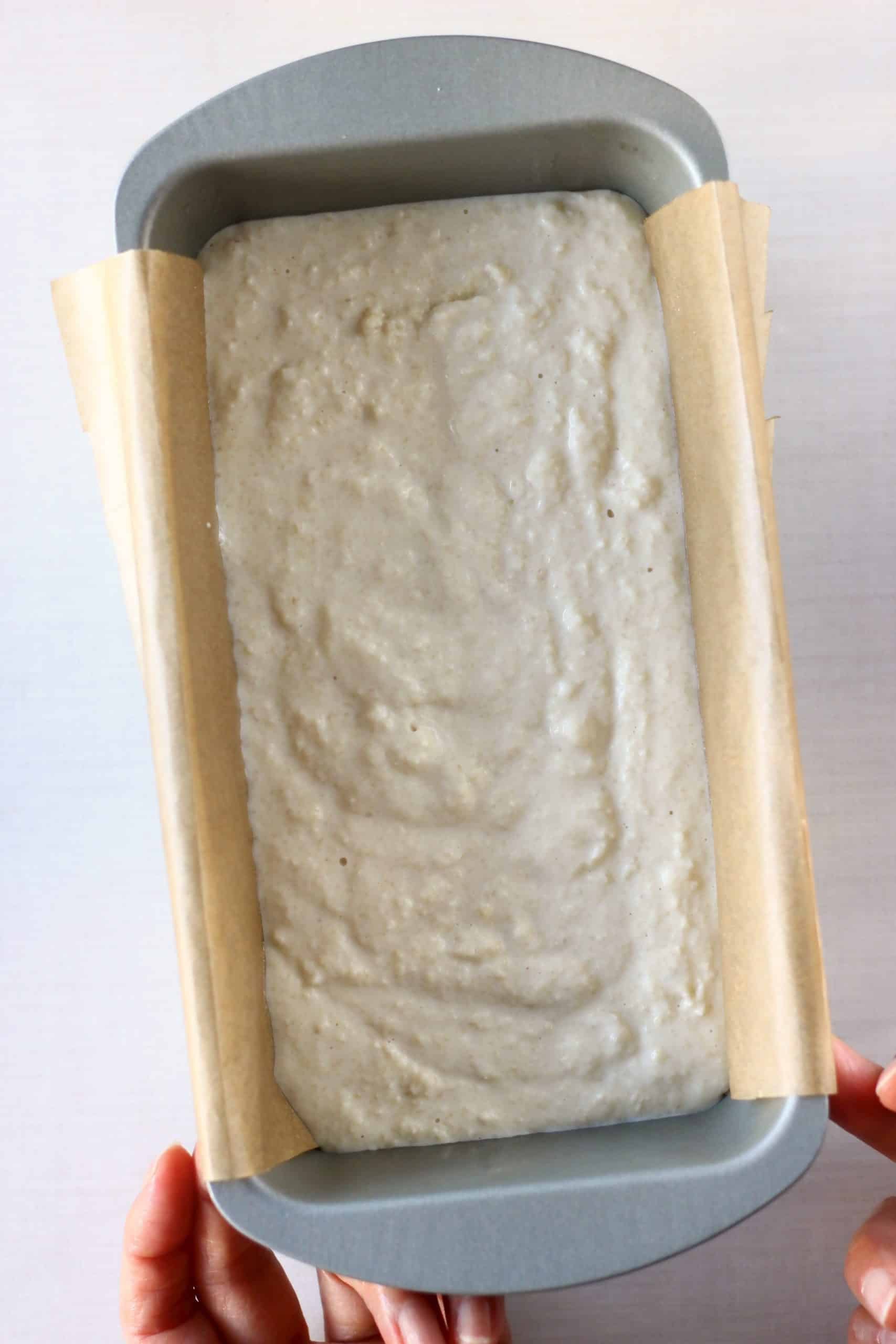 Raw gluten-free vegan almond bread batter in a loaf tin lined with baking paper