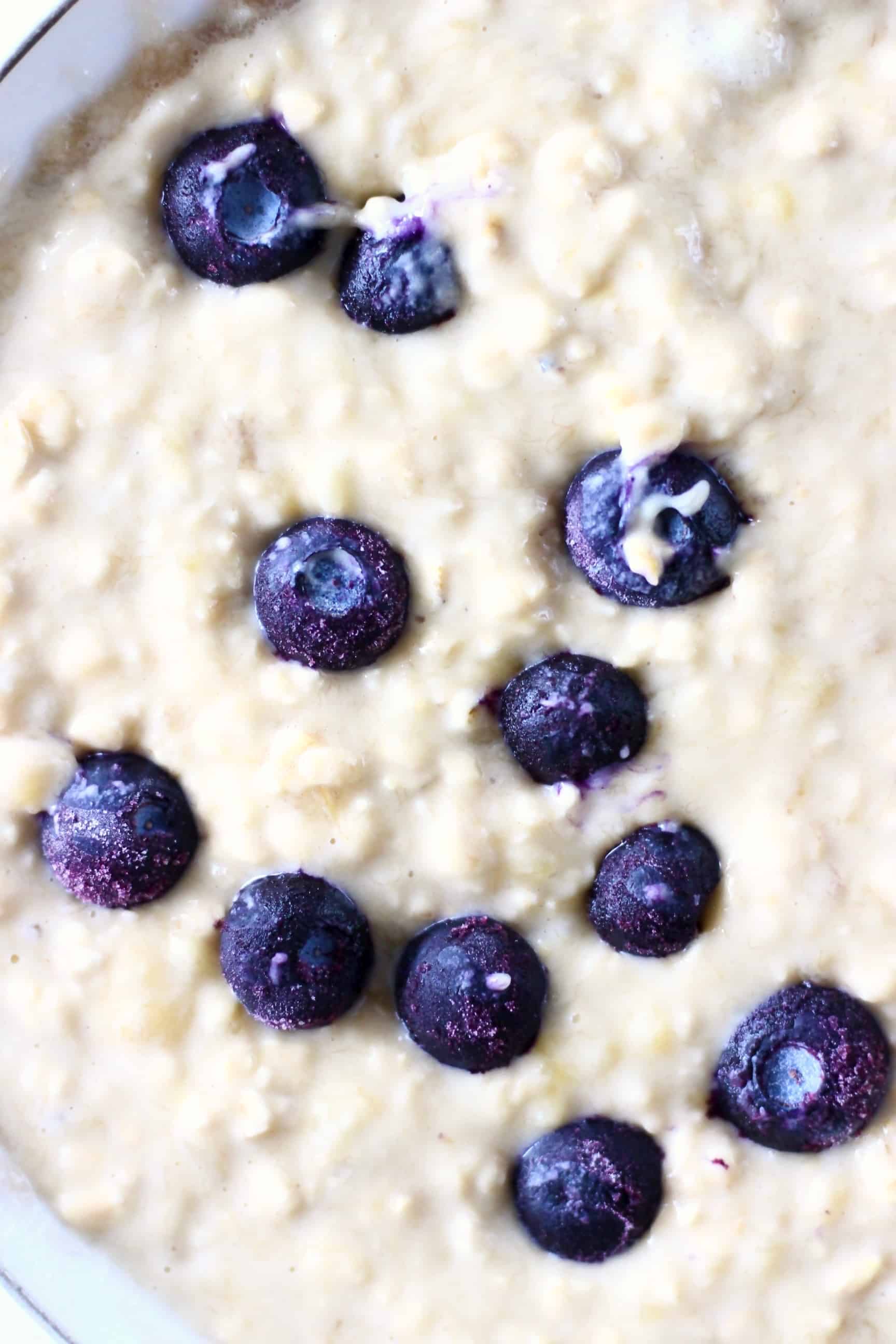 These Gluten-Free Vegan Blueberry Oatmeal Muffins are moist and fluffy, slightly chewy and filled with jammy blueberries! They make a great healthier breakfast, dessert or snack! Dairy-free, egg-free and refined sugar free. #rhiansrecipes #vegan #dairyfree #glutenfree #muffins #dessert Gluten-free vegan blueberry oatmeal muffin batter in a bowl