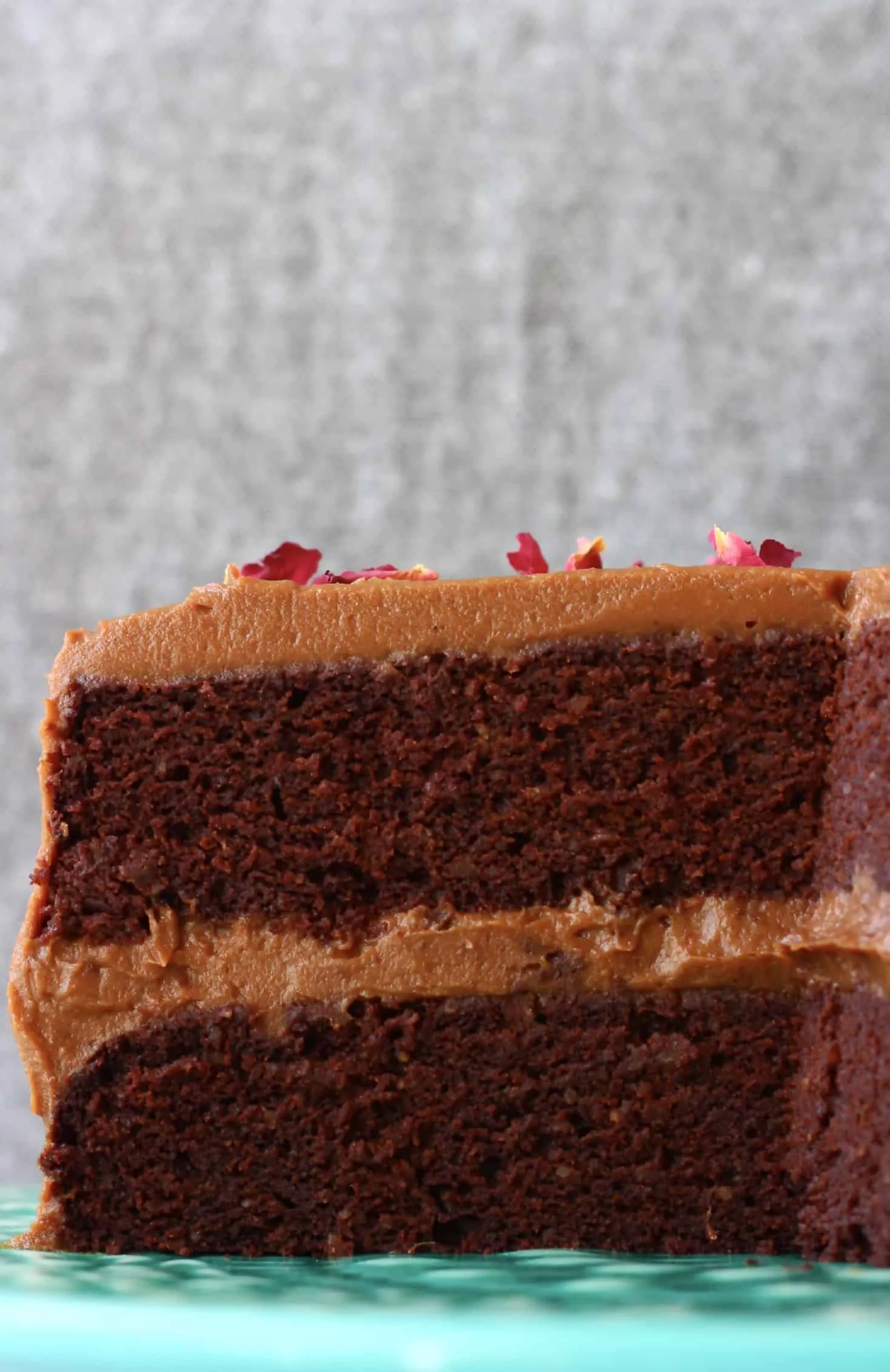 Gluten-free vegan chocolate cake with chocolate frosting on a cake stand