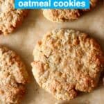 Six golden brown cookies against a sheet of brown baking paper
