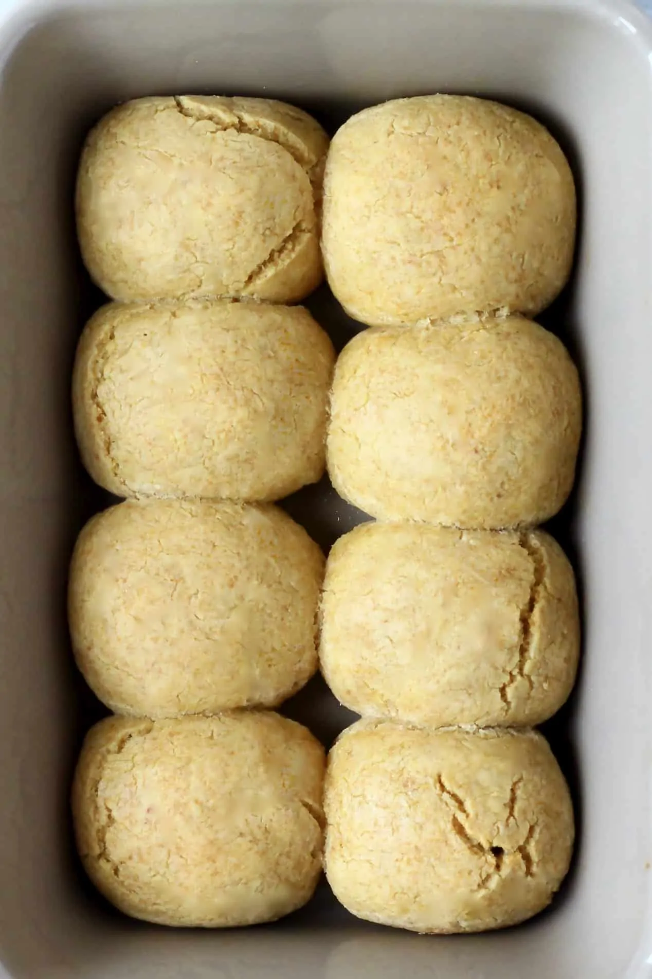 8 gluten-free dinner rolls in a baking dish