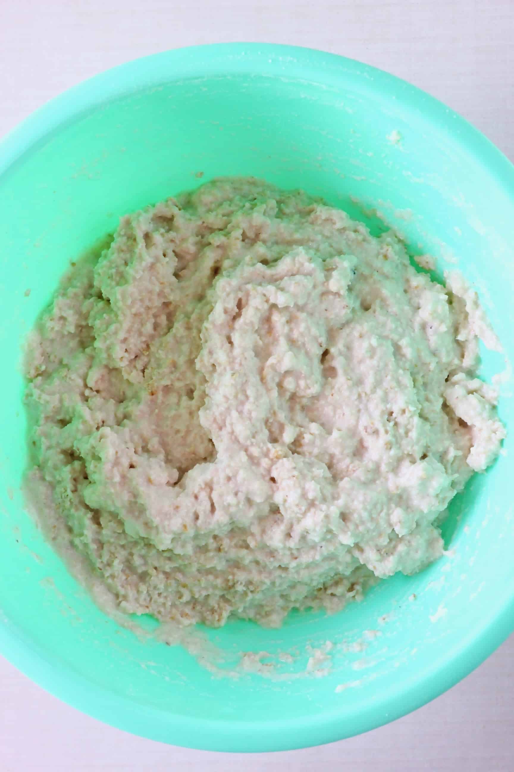 This Gluten-Free Vegan Oat Bread is soft on the inside, crusty on the outside, nutty, slightly chewy, and unbelievably easy to make! It's also no-knead, yeast-free and completely free from sugar! It's made in one bowl using simple ingredients, slices well and is perfect for making sandwiches! Dairy-free, soy-free, oil-free, corn-free, egg-free and nut-free optional. #rhiansrecipes #baking #bread #glutenfree #yeastfree #vegan #dairyfree #eggfree Raw gluten-free vegan oat bread dough in a bowl