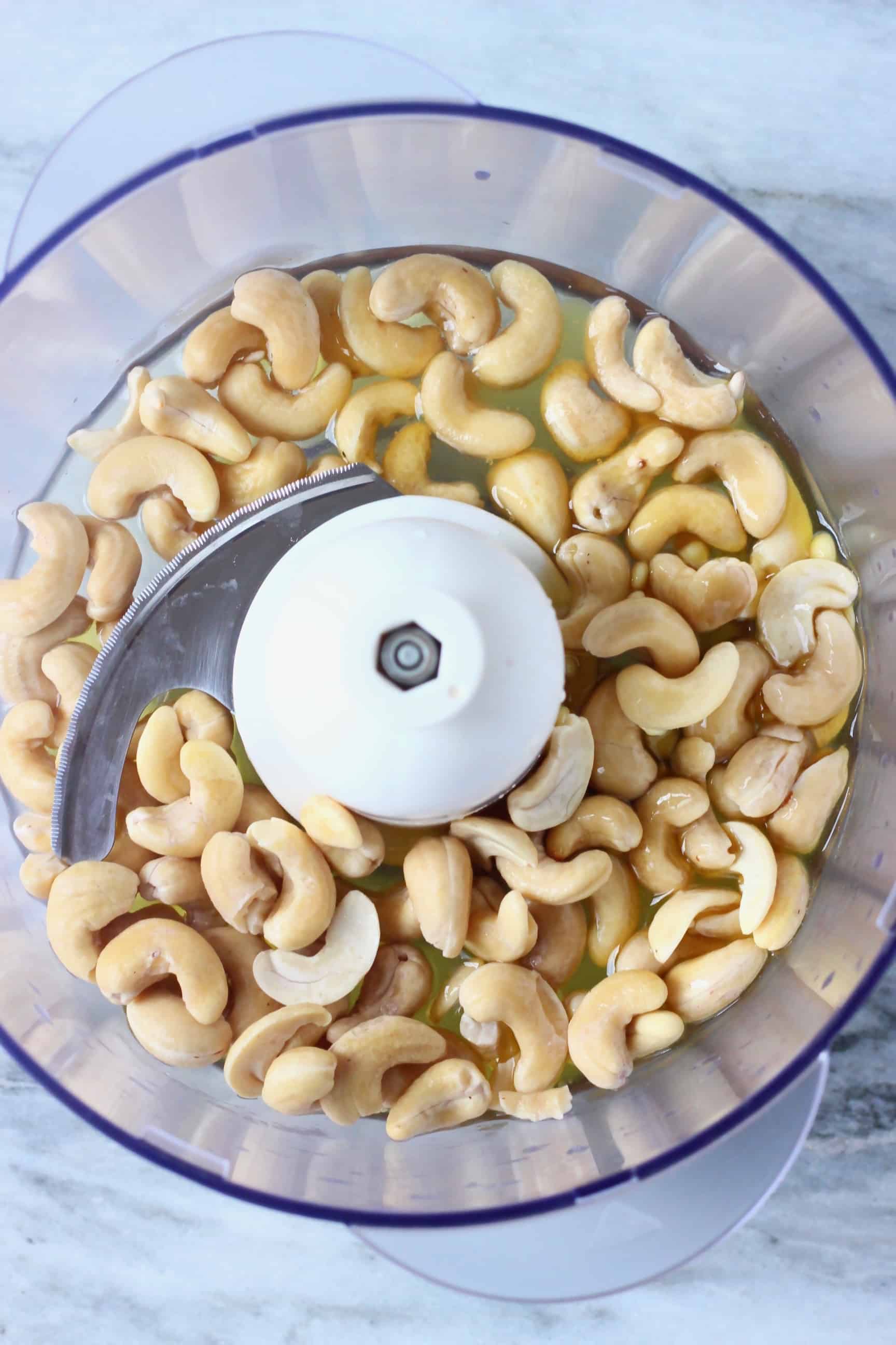 Cashew nuts, maple syrup and cacao butter in a food processor 