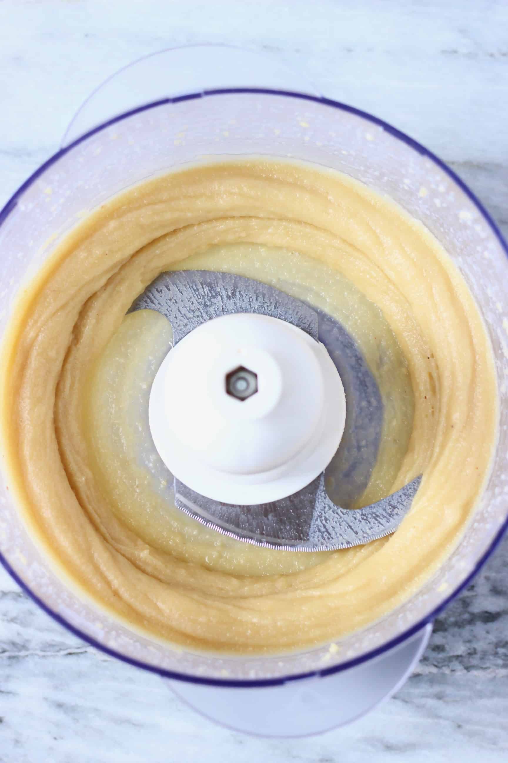 Blended vegan white chocolate truffle mixture in a food processor 