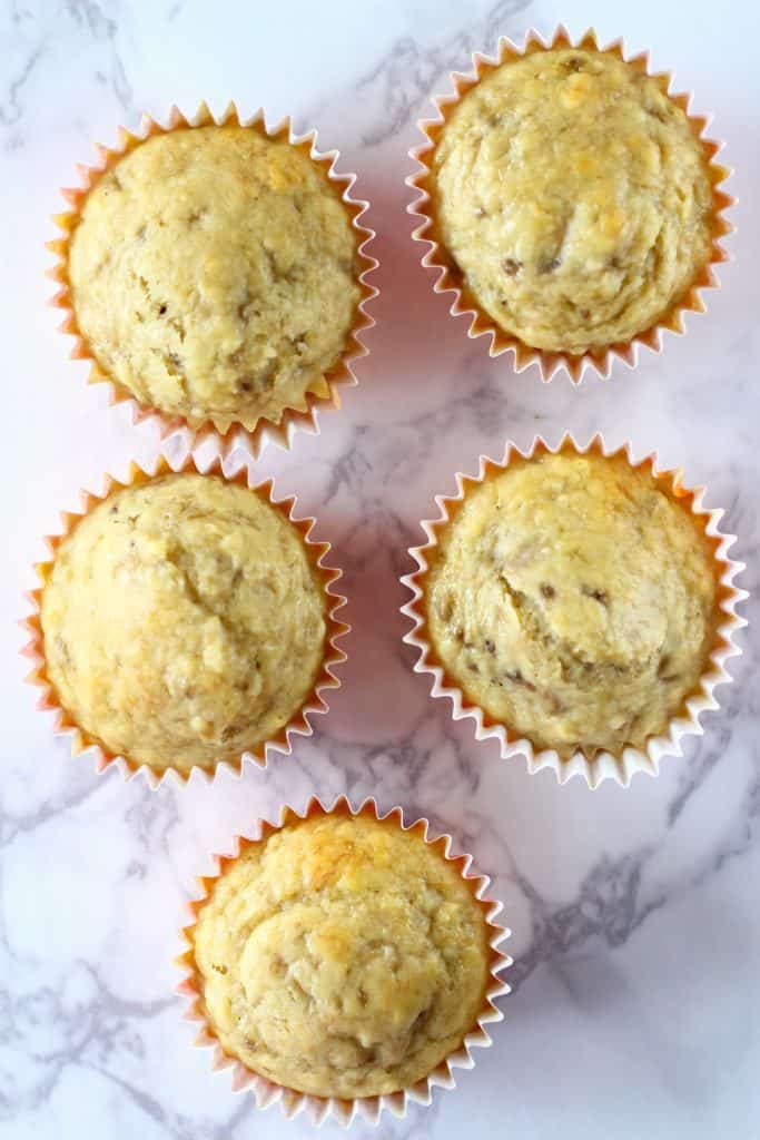 Five banana cupcakes on a marble background
