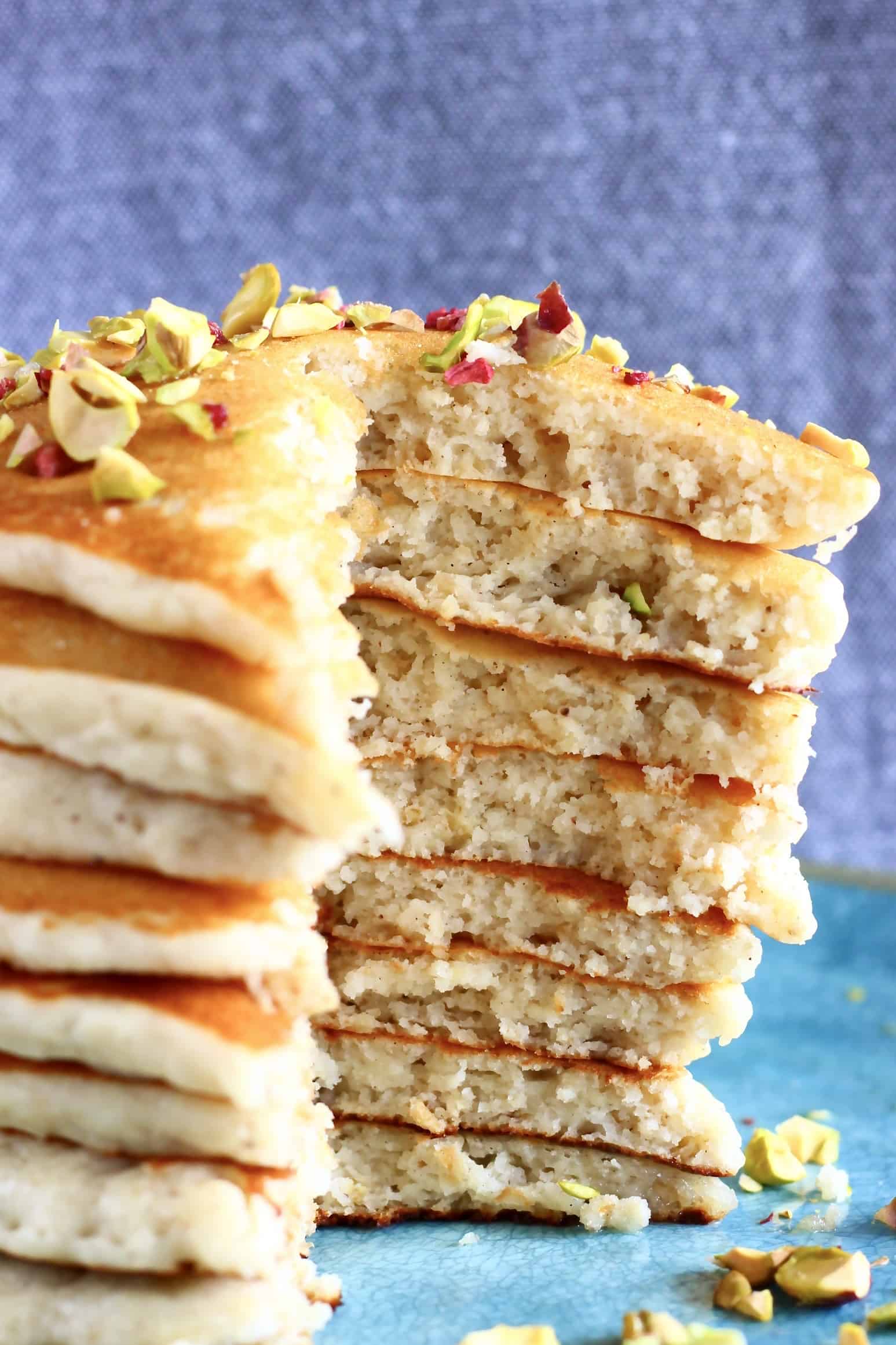 A stack of oatmeal pancakes with a mouthful cut out of it