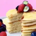 A stack of gluten-free vegan pancakes topped with berries