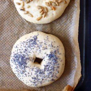 Two bagels on a sheet of brown baking paper