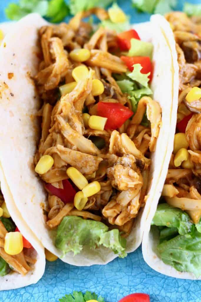 Shredded mushroom tacos with sweetcorn and red pepper on a blue plate
