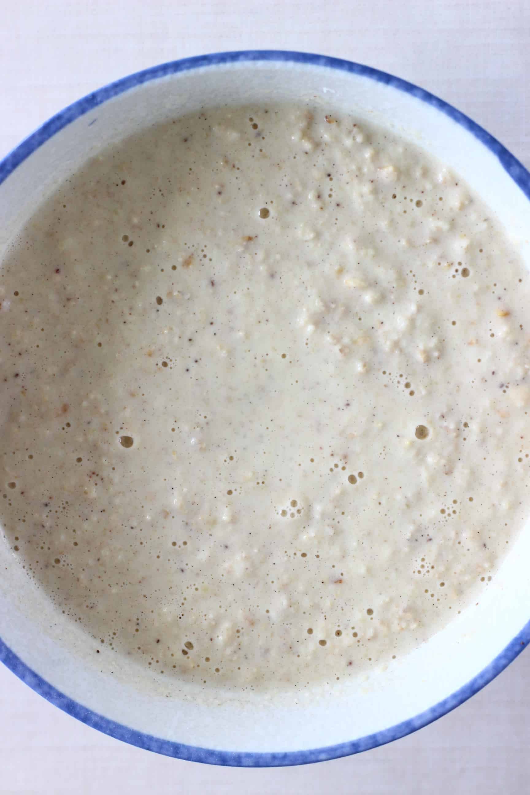 Raw gluten-free vegan oatmeal pancake batter in a mixing bowl