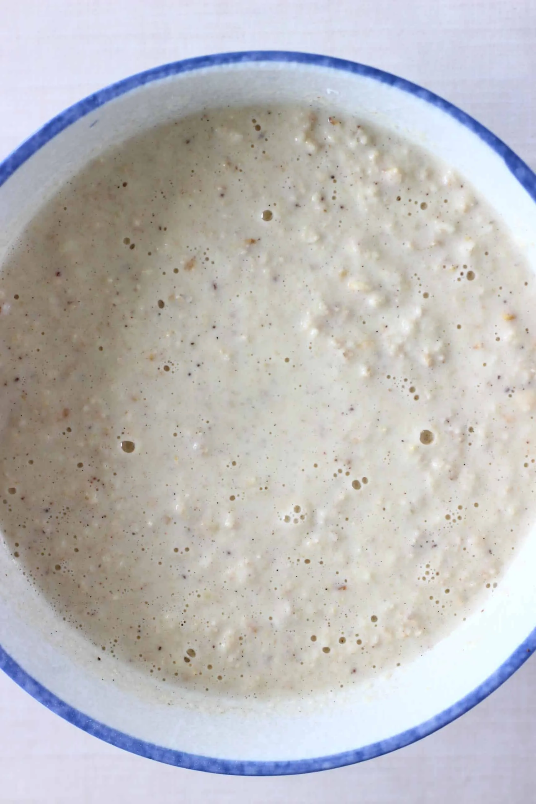 Raw gluten-free vegan oatmeal pancake batter in a mixing bowl 