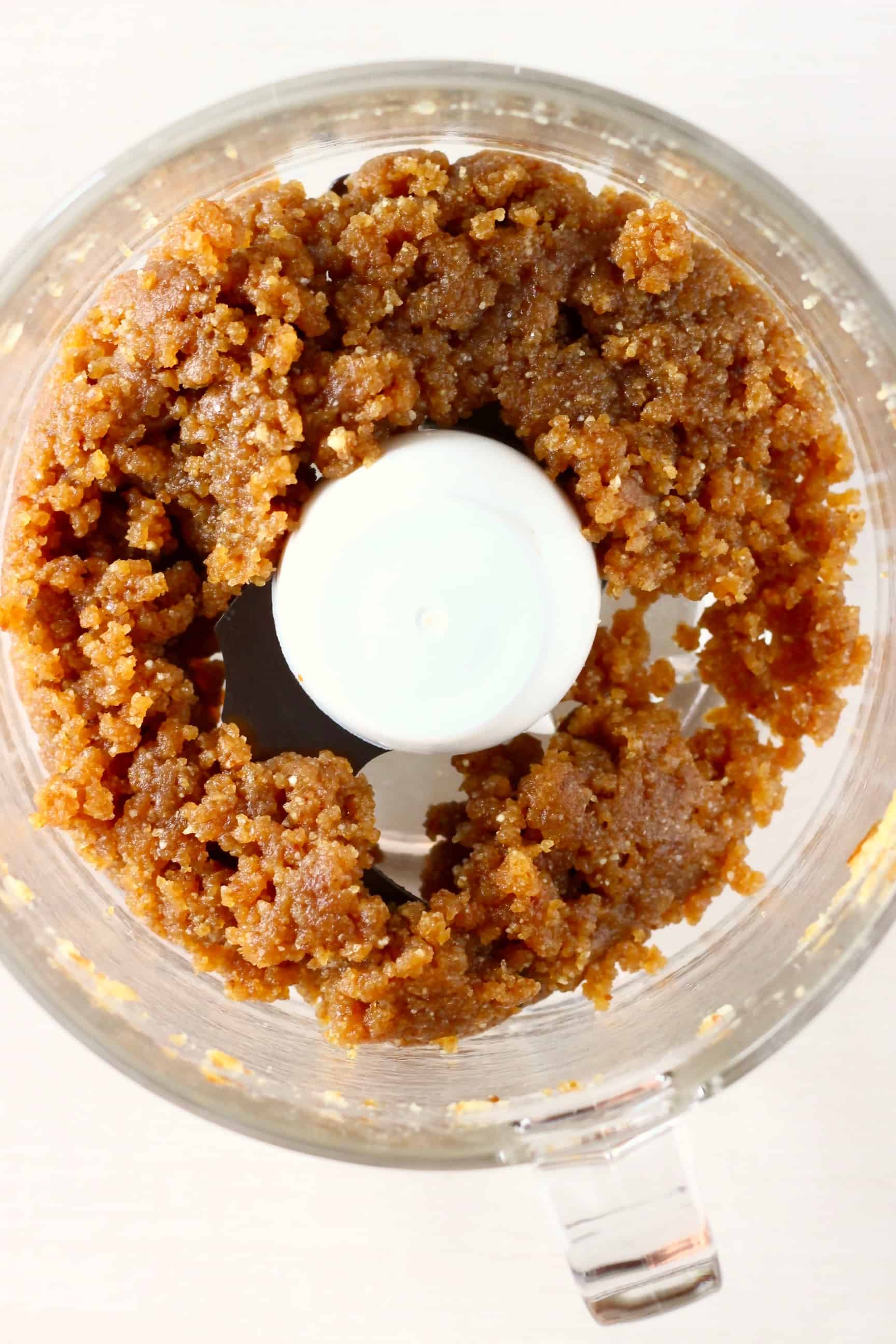 Brown vegan energy balls mixture in a food processor