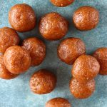 Lots of brown round energy balls on a blue plate