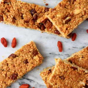 Five vegan granola bars on a marble background