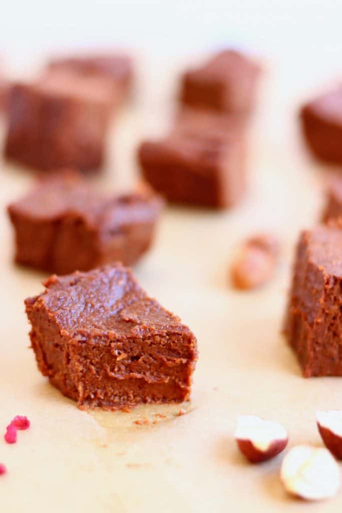 Nine squares of chocolate sweet potato fudge against a sheet of brown baking paper
