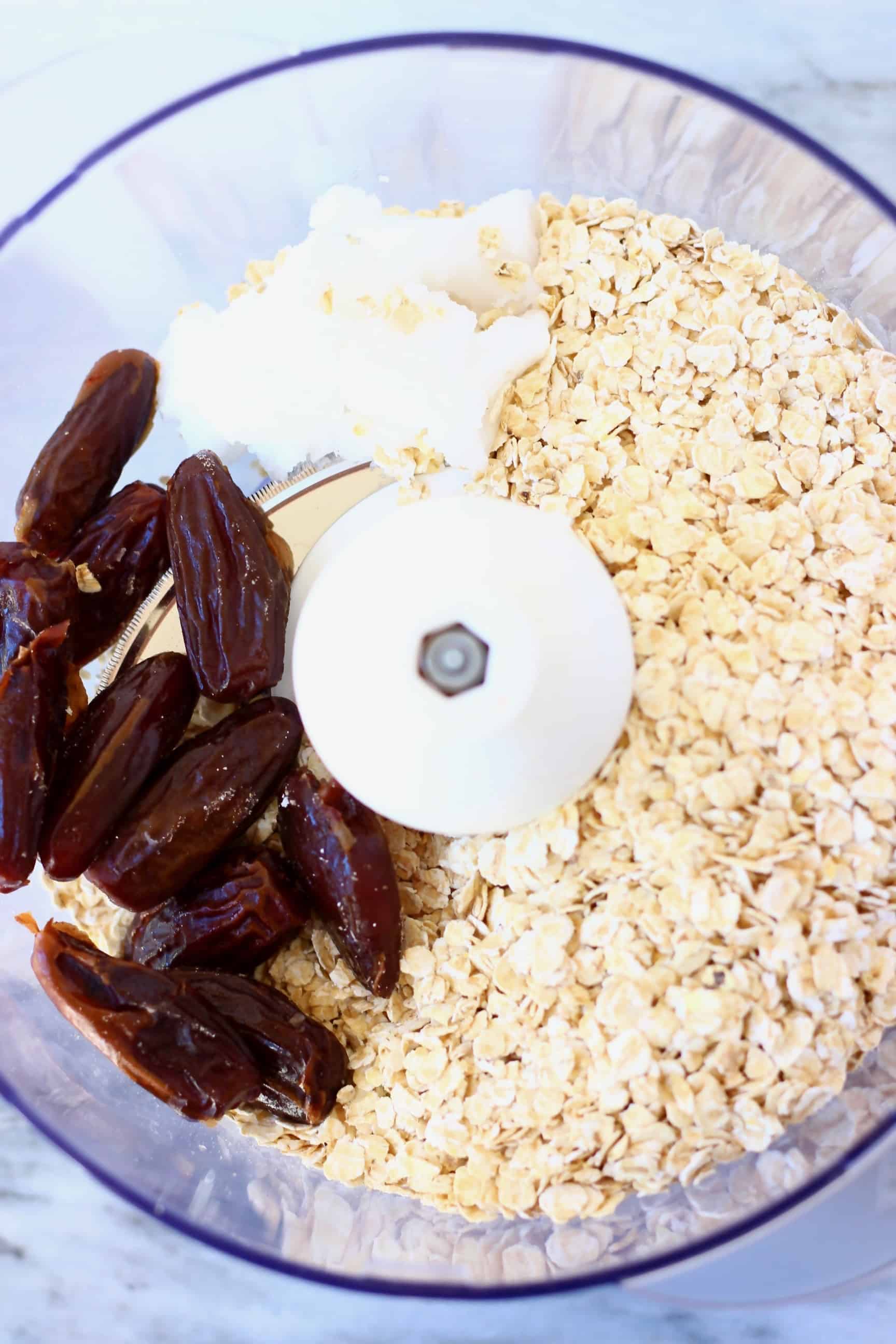 Oats, dates and coconut oil in a food processor