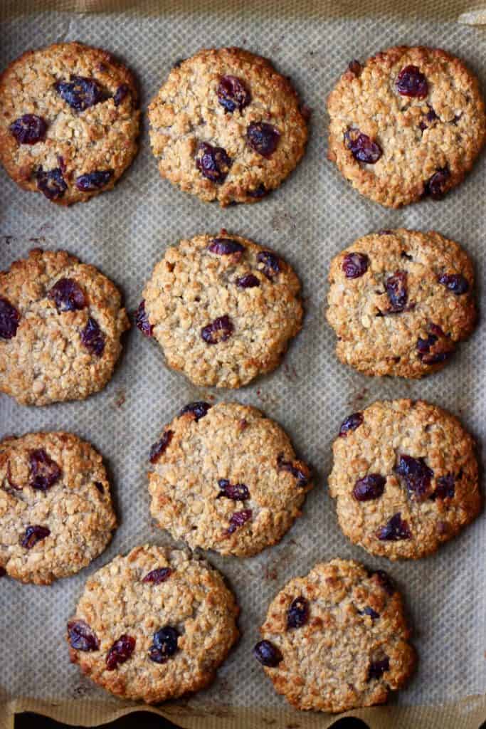11 oatmeal cookies with dried cranberries on brown baking paper