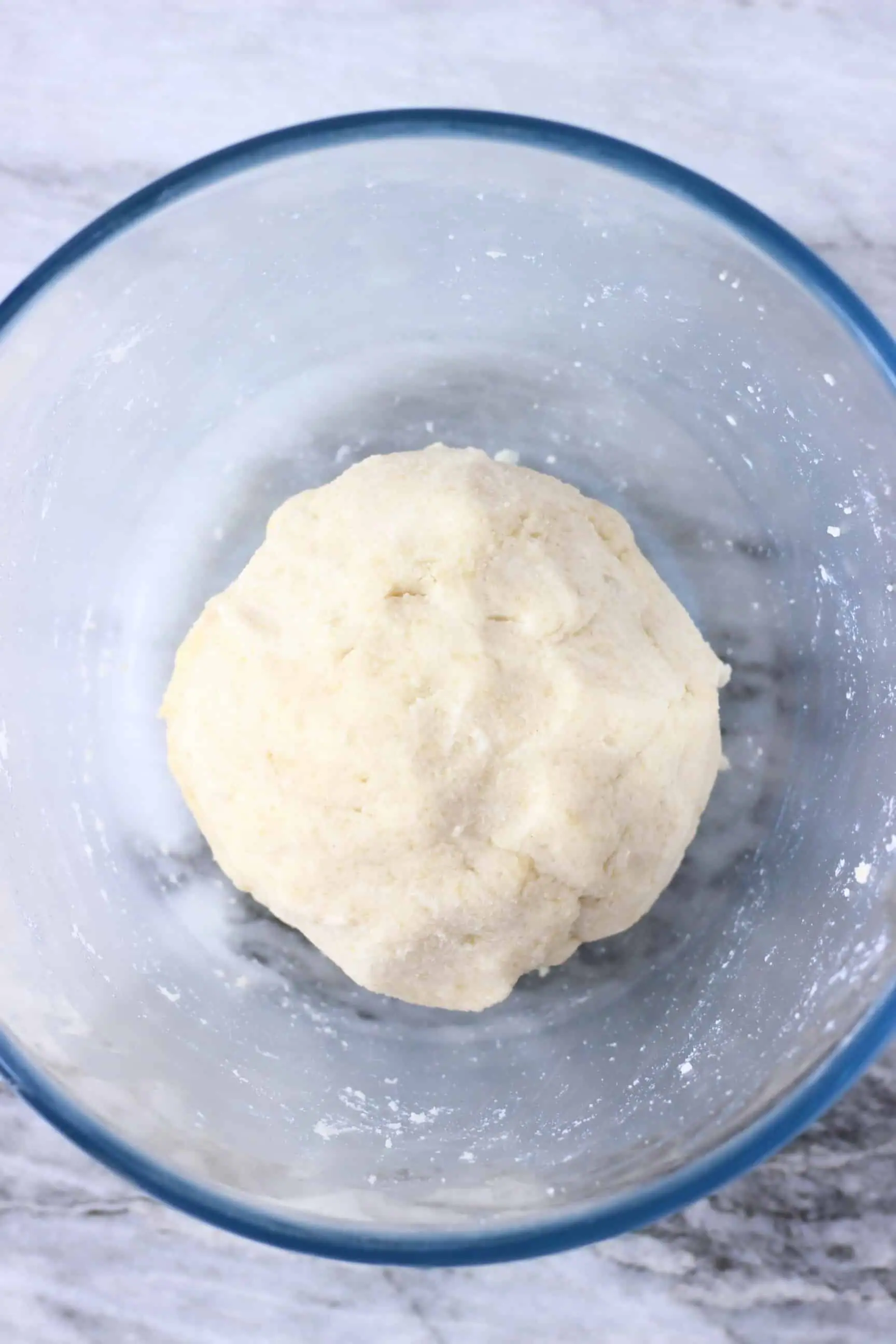 Raw gluten-free vegan pastry dough in a glass mixing bowl