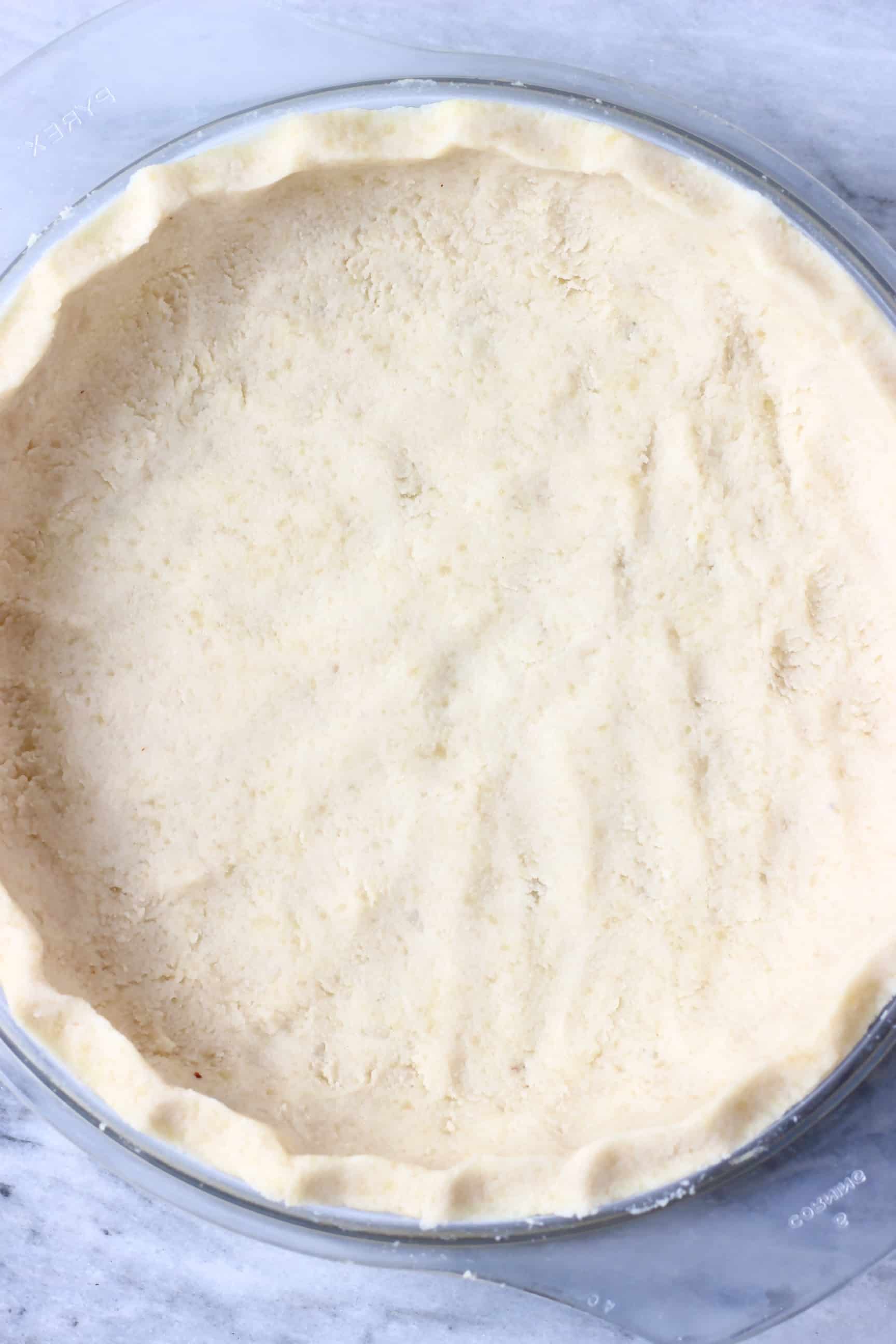 Raw gluten-free vegan pastry pie crust in a glass pie dish