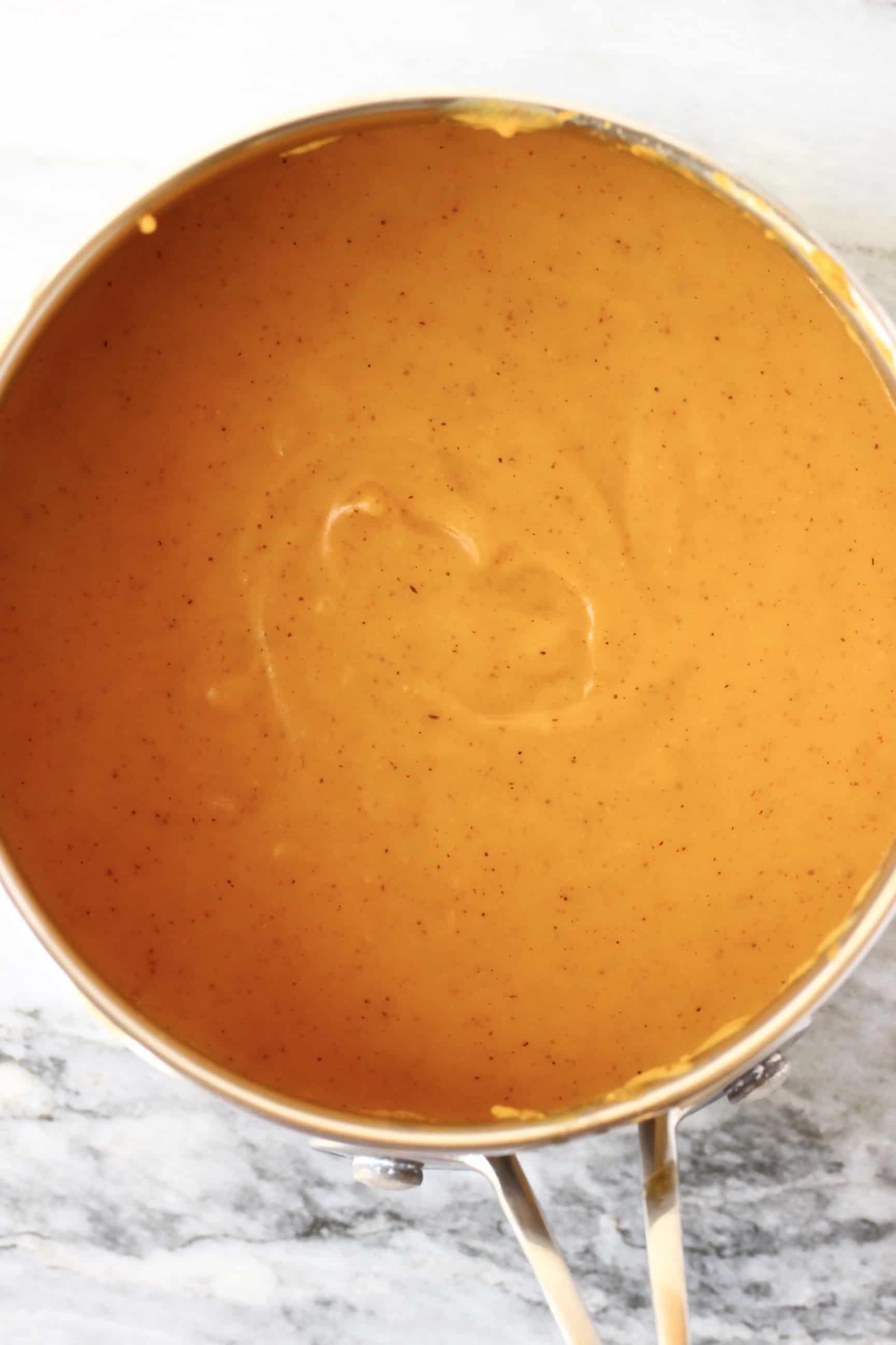 Orange vegan sweet potato pie filling in a silver pan