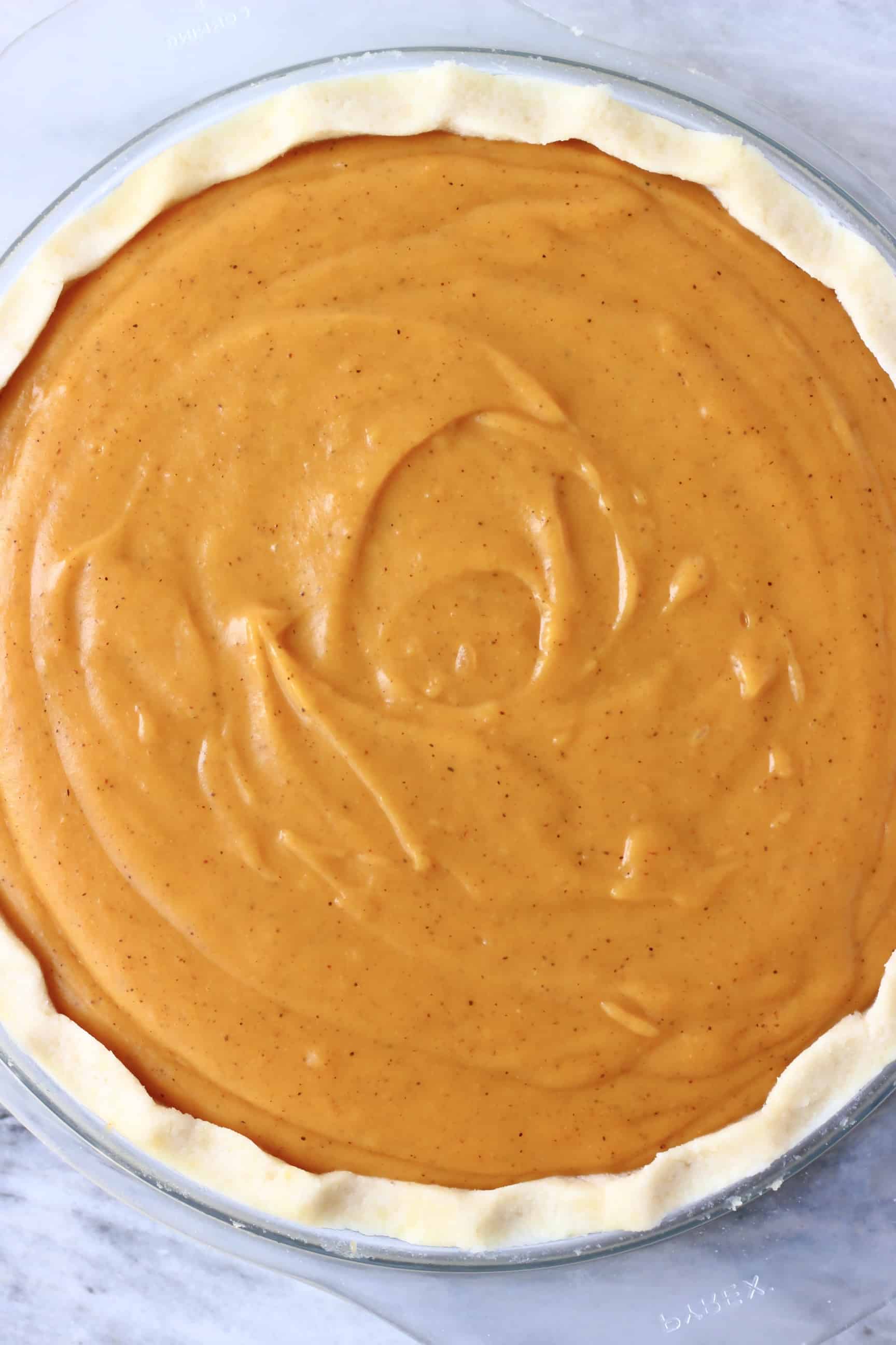 Raw vegan sweet potato pie in a glass pie dish