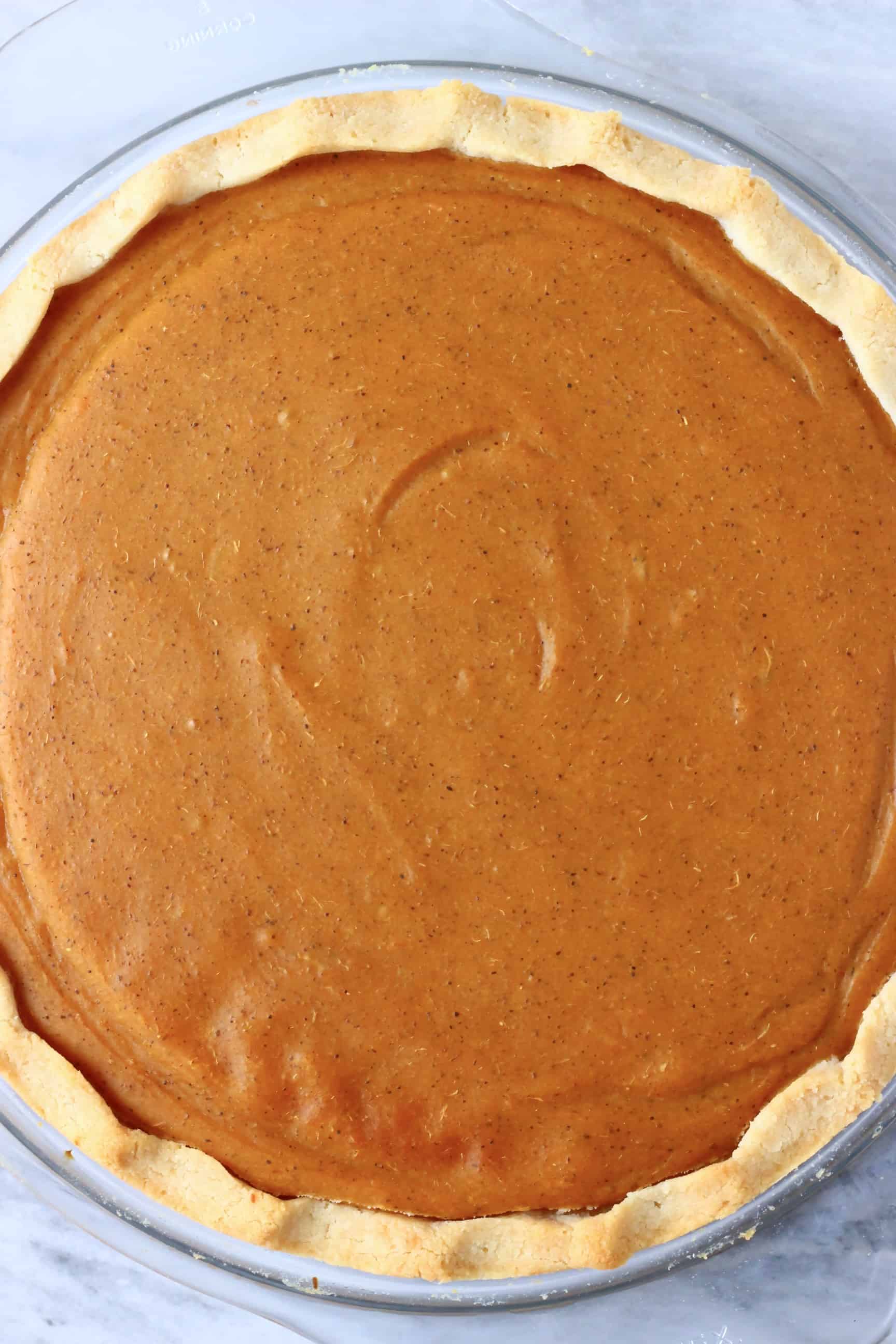 Cooked vegan sweet potato pie in a glass pie dish