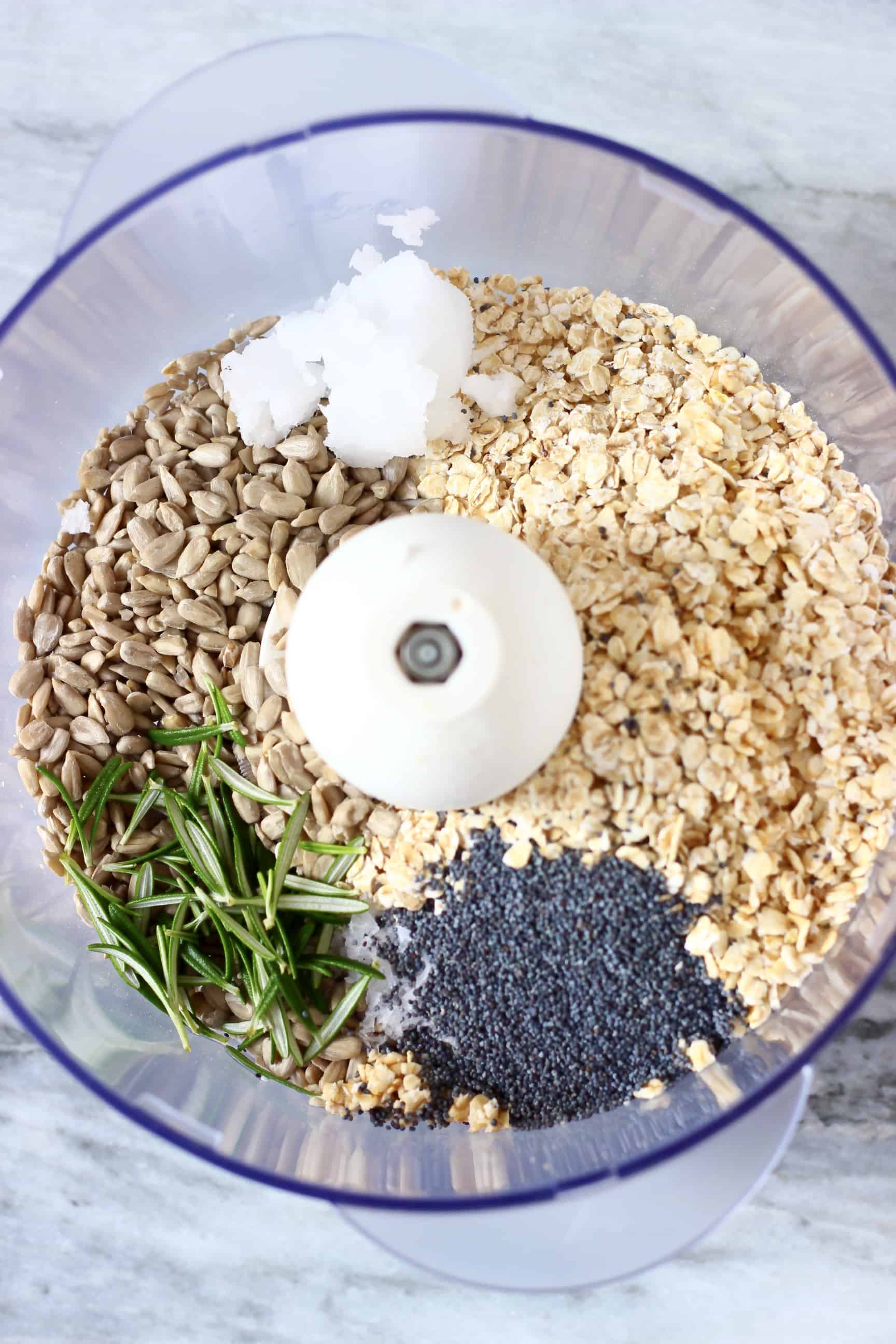 Oats, sunflower seeds, rosemary, poppy seeds, coconut oil and salt in a food processor