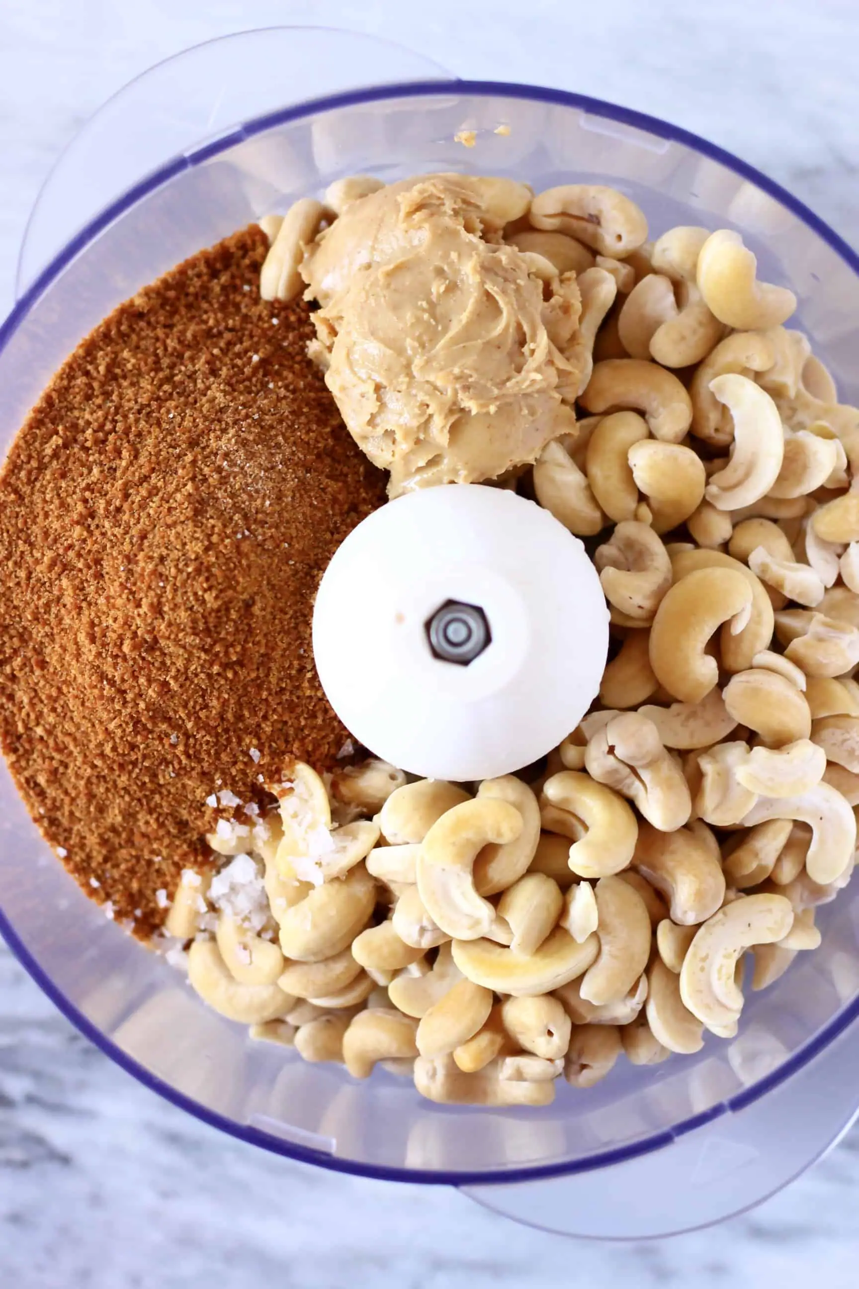 Cashew nuts, peanut butter and coconut sugar in a food processor