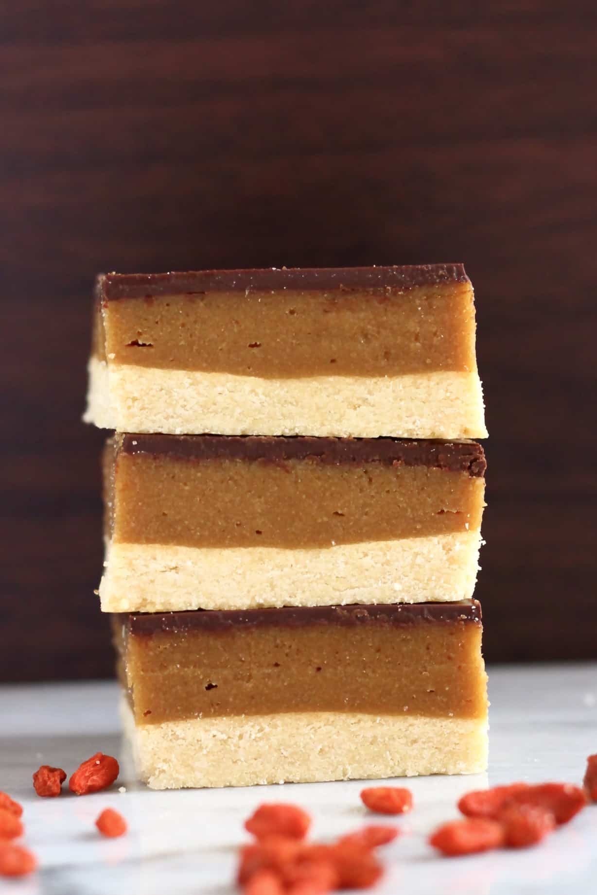 A stack of three vegan millionaire shortbread squares 