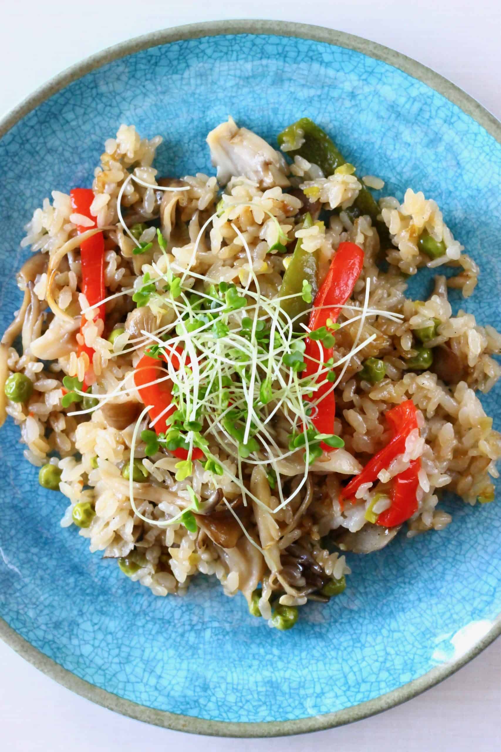 Mushroom rice with peppers on a blue plate