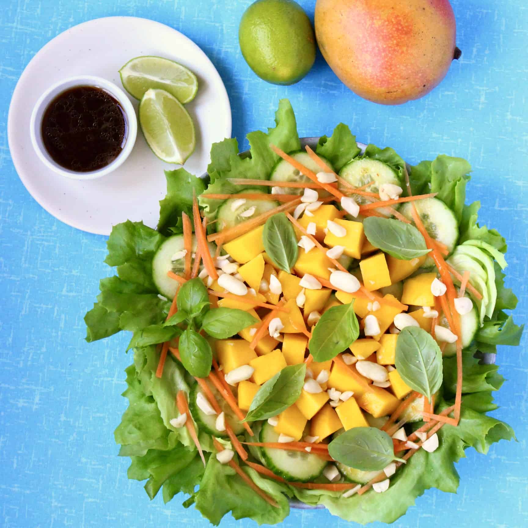 Mango salad with peanuts, cucumber, lettuce, carrots and basil 
