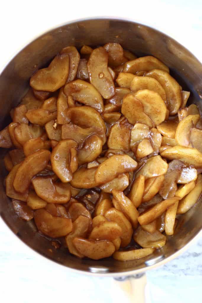 Cooked brown sliced apples in a saucepan