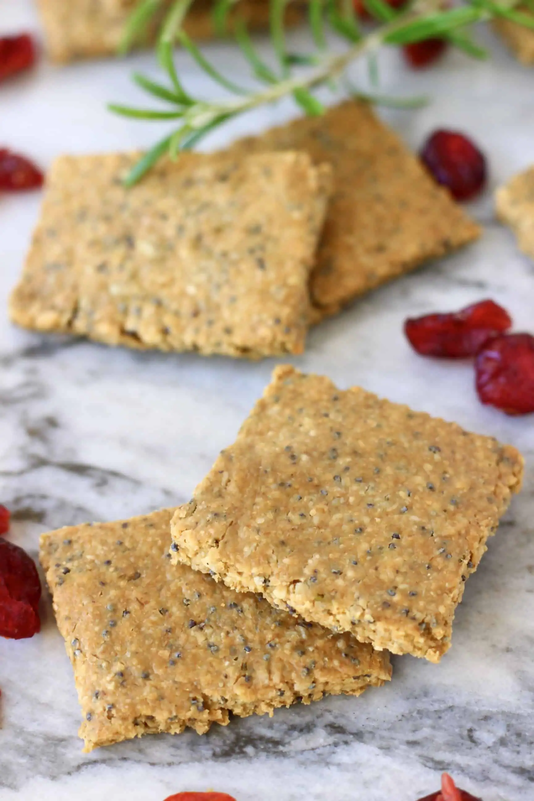 Four brown square crackers on a marble background