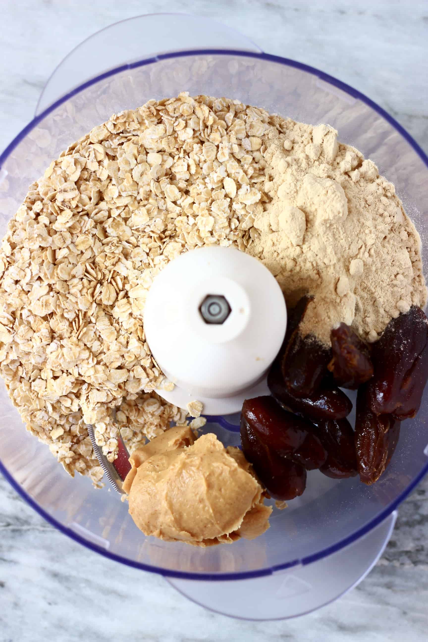 Oats, vegan protein powder, peanut butter and dates in a food processor