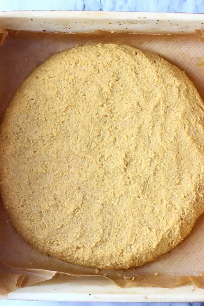A circle of pumpkin scone dough in a baking tray
